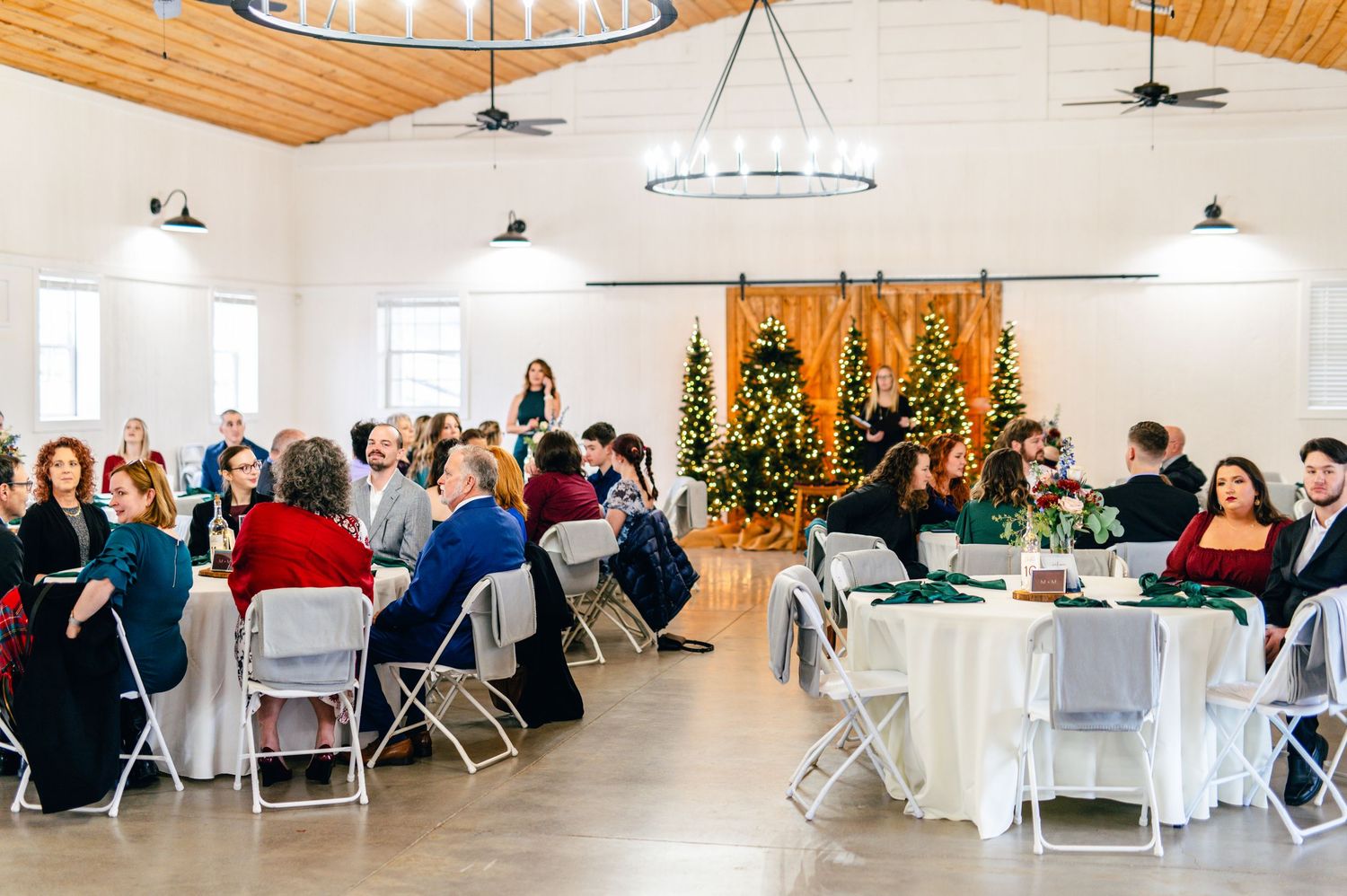 Wedding reception setup with white tables and chairs in bright indoor venue. Knoxville Wedding Photographer. Winding Creek, Rockford, TN