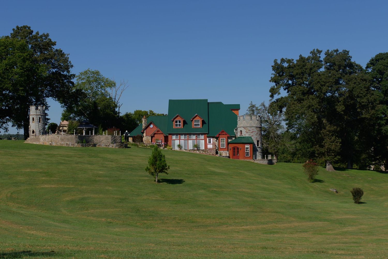 Panoramic view of green hillside with colorful buildings in the distance. Knoxville Wedding Photographer