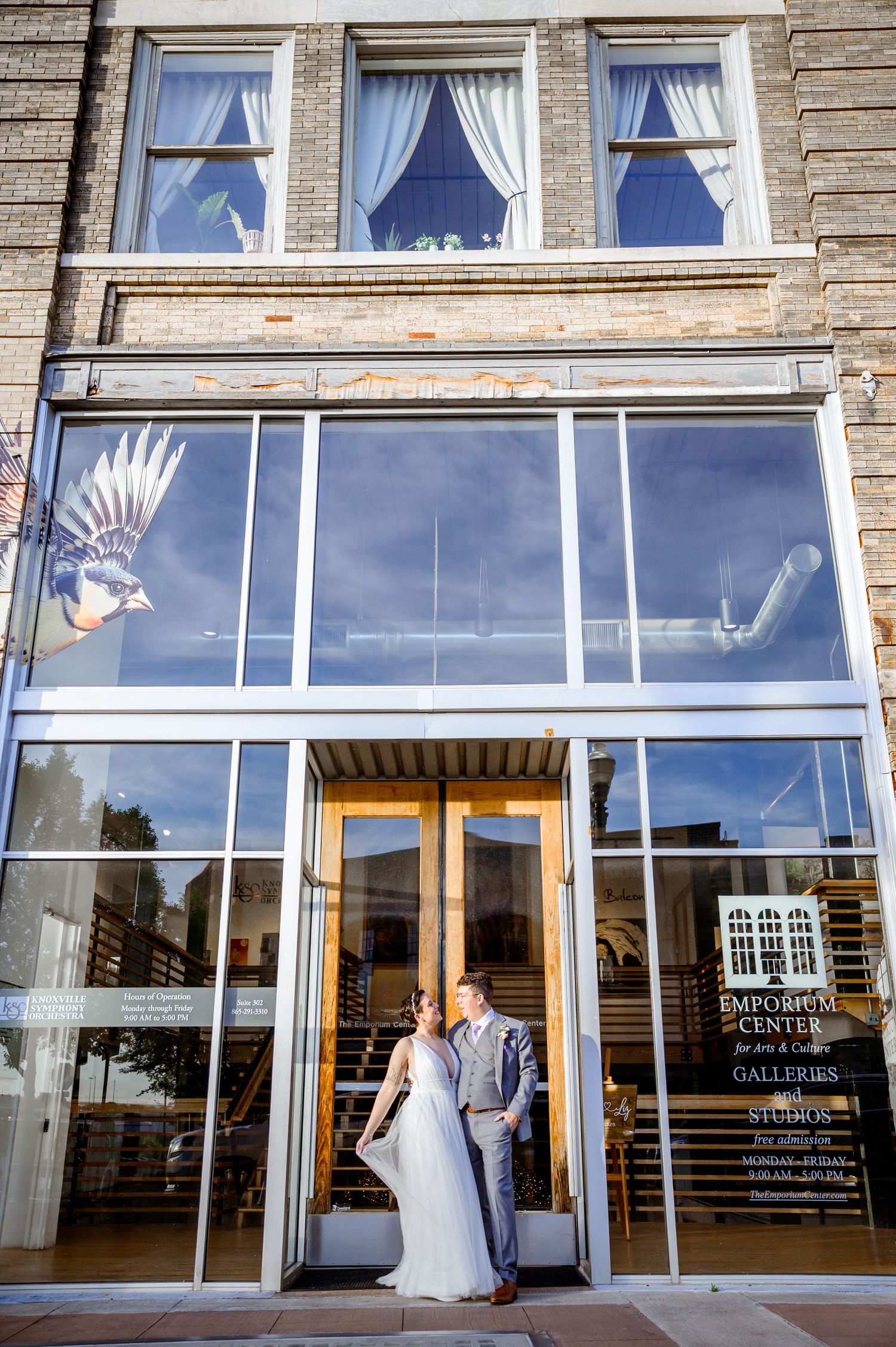 Panoramic view of a modern brick building with large glass windows and white curtains. Knoxville Wedding Photographer