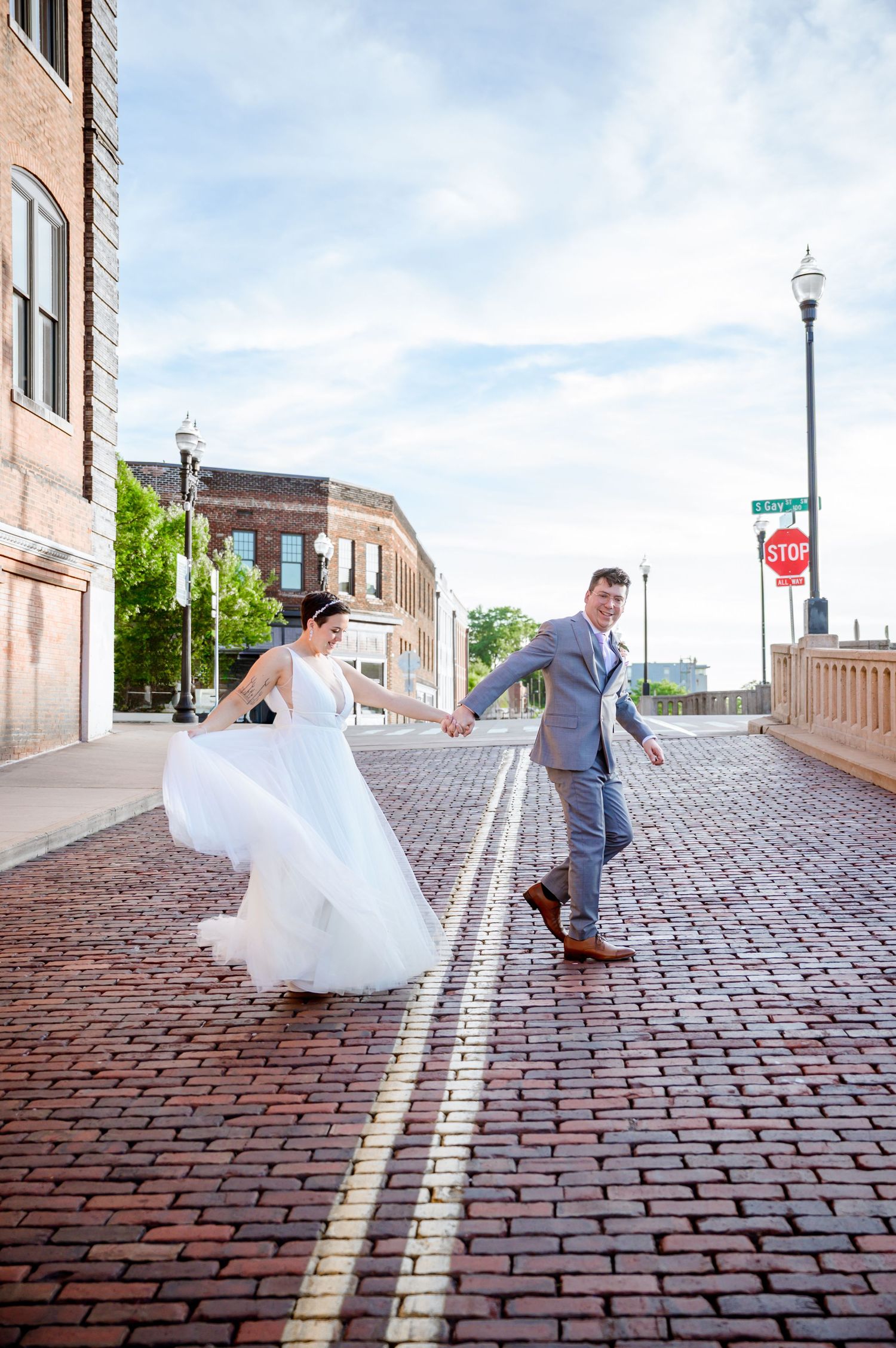 Wedding sequence on brick cobblestone street with urban architecture in background. Knoxville Wedding Photographer