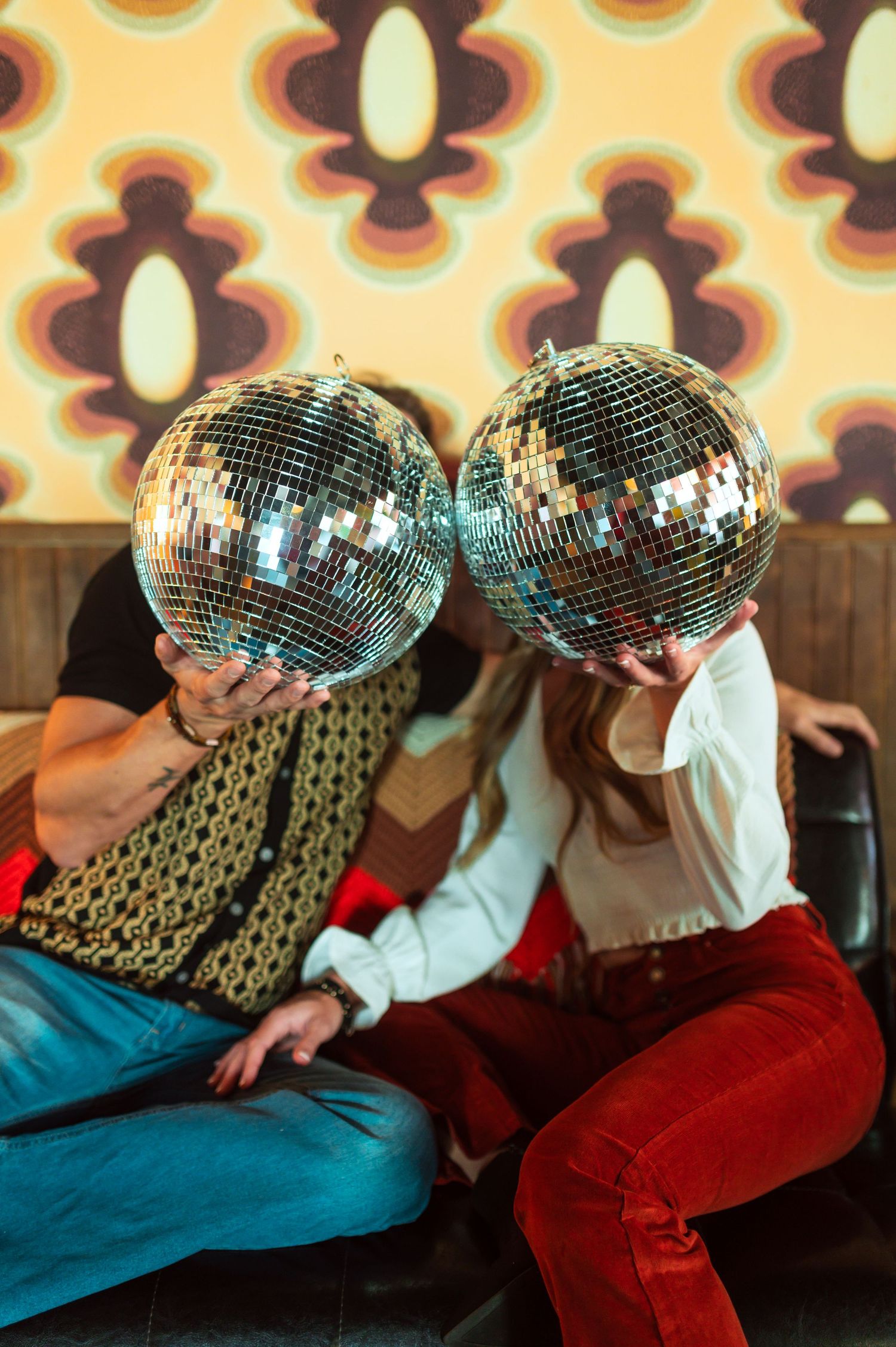 Creative portrait with disco balls replacing heads in a stylized indoor setting. Knoxville Couple Photographer