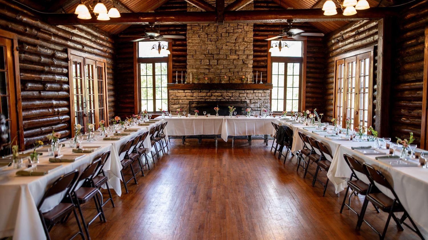 Panoramic view of rustic reception hall with exposed brick walls and pendant lighting. Knoxville Wedding Photographer. Norris State park