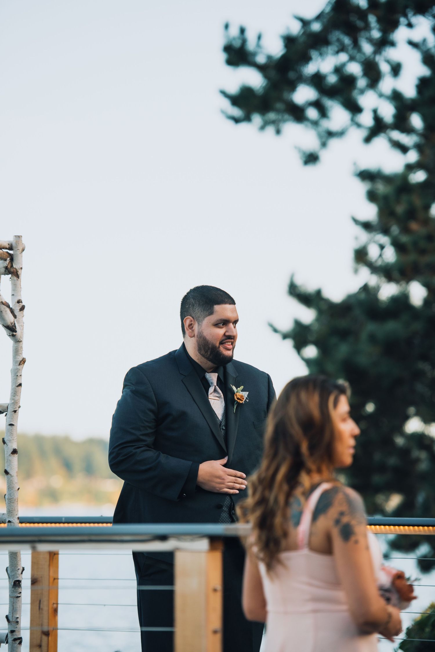 Wedding party members share laughter on outdoor deck during reception celebrations. Knoxville Wedding Photographer