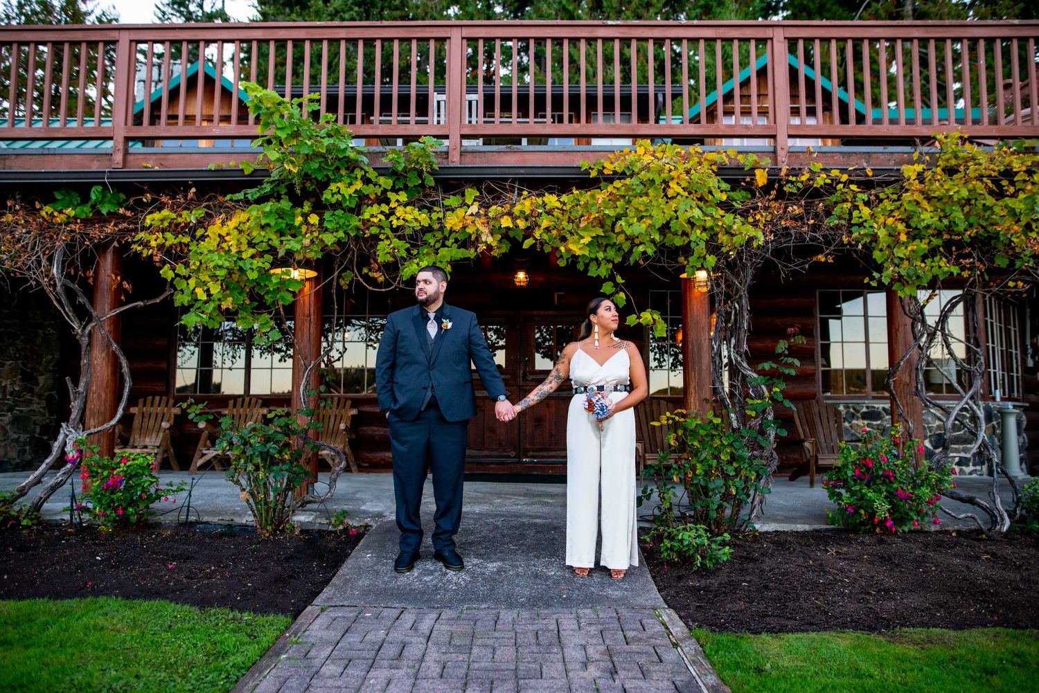 Couple poses on outdoor patio with wooden railings and greenery. Knoxville Wedding Photographer