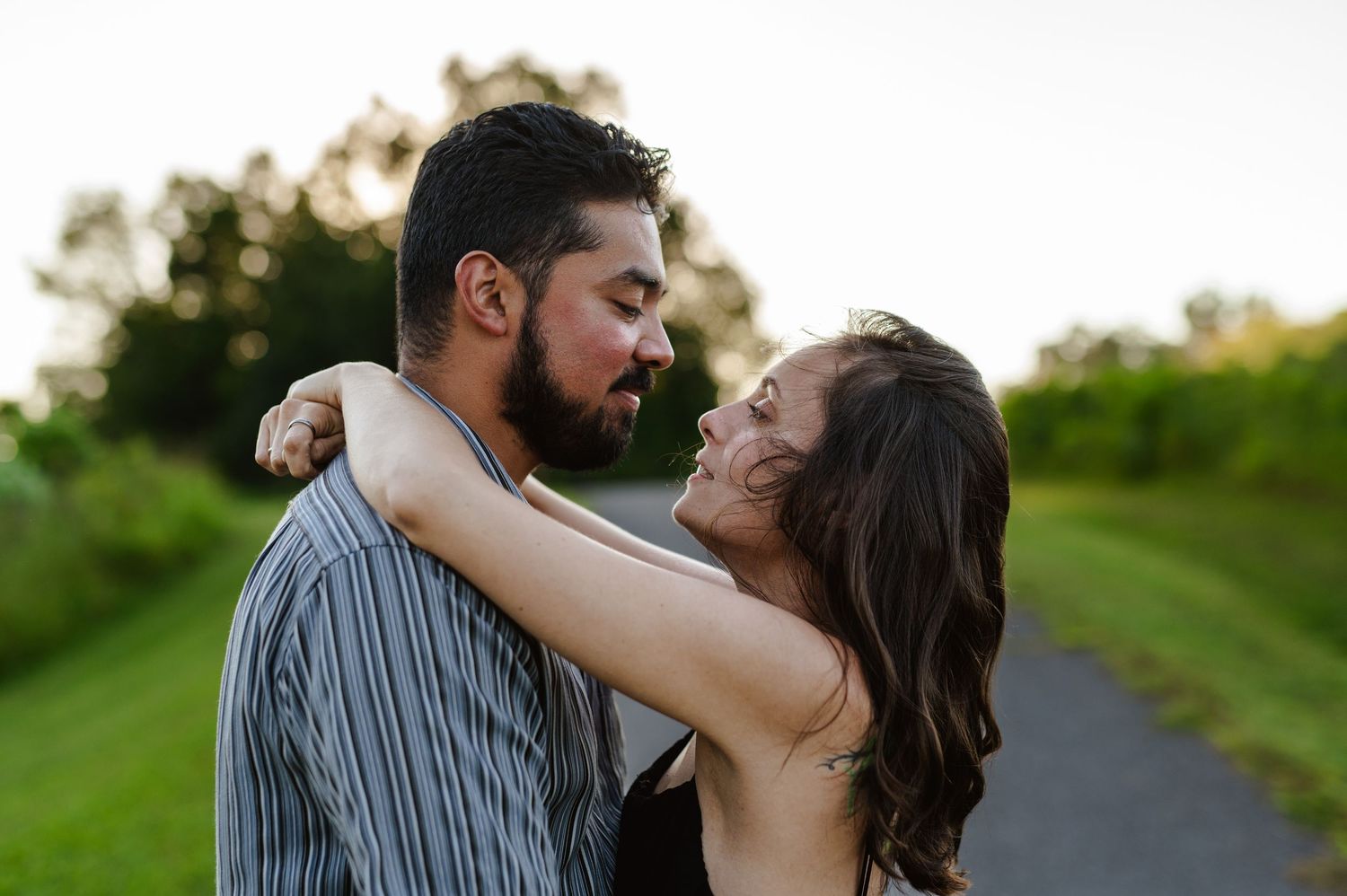 Romantic outdoor portrait of a couple sharing an intimate moment on a path. Knoxville Couple Photographer