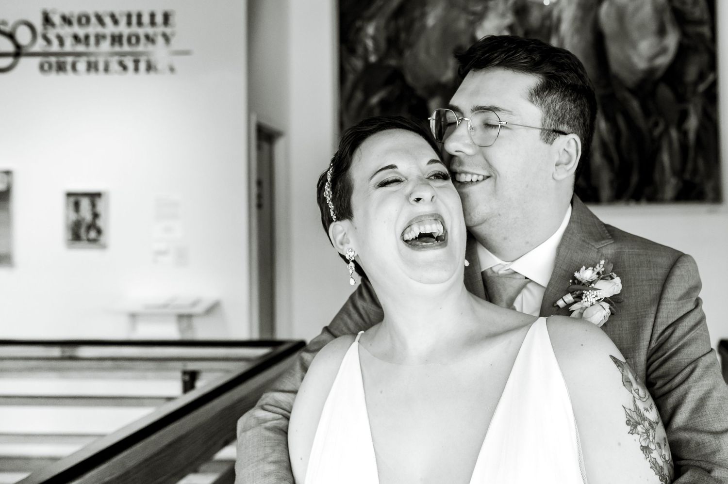 Black and white wedding portraits showing joyful moments in an art gallery setting. Knoxville Wedding Photographer