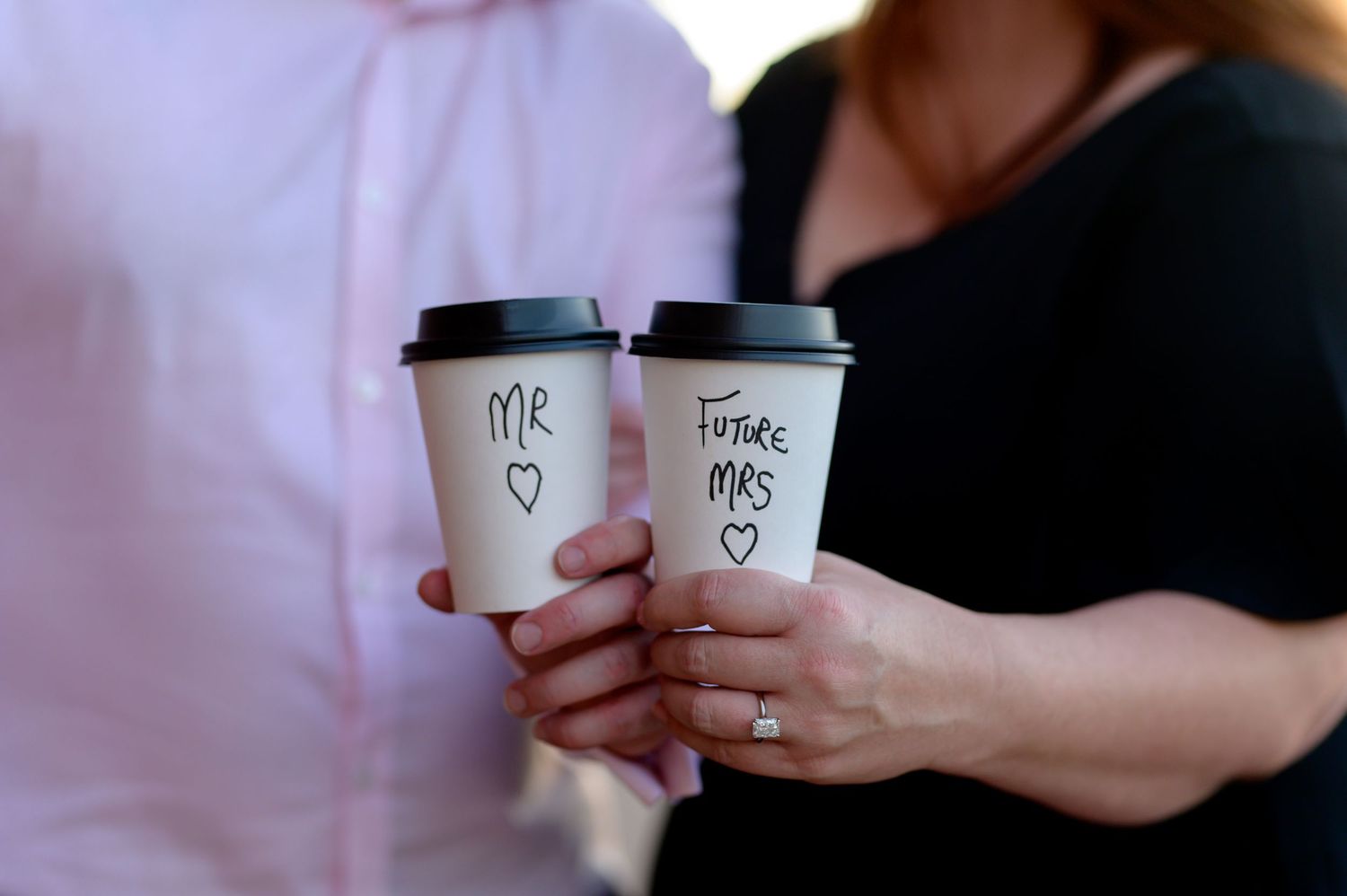 Two coffee cups being held together in a romantic moment. Knoxville Couple Photographer. Downtown Knoxville. Old City Knoxville, TN