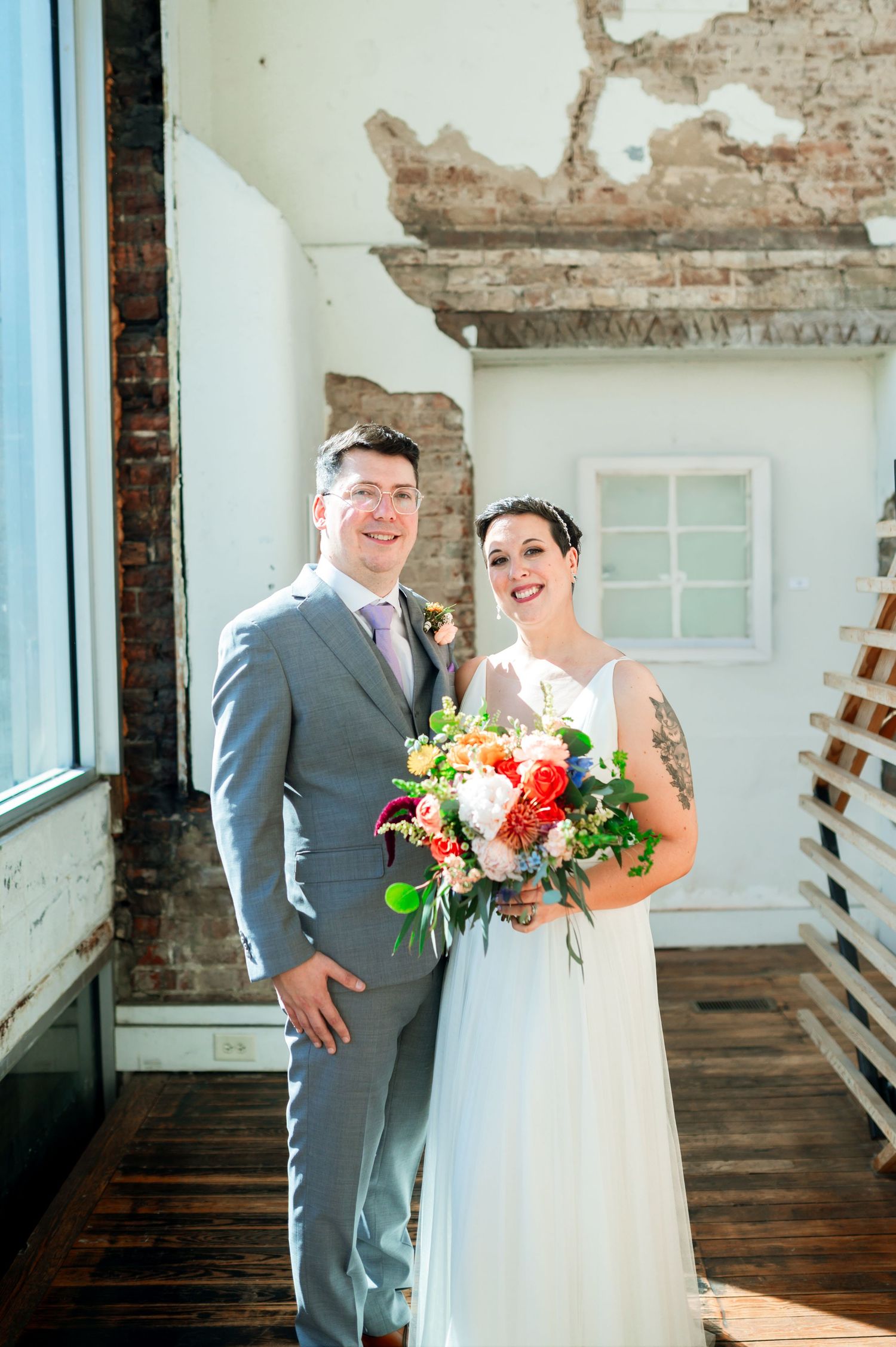 Wedding photos in a bright indoor space with exposed brick walls and natural lighting. Knoxville Wedding Photographer