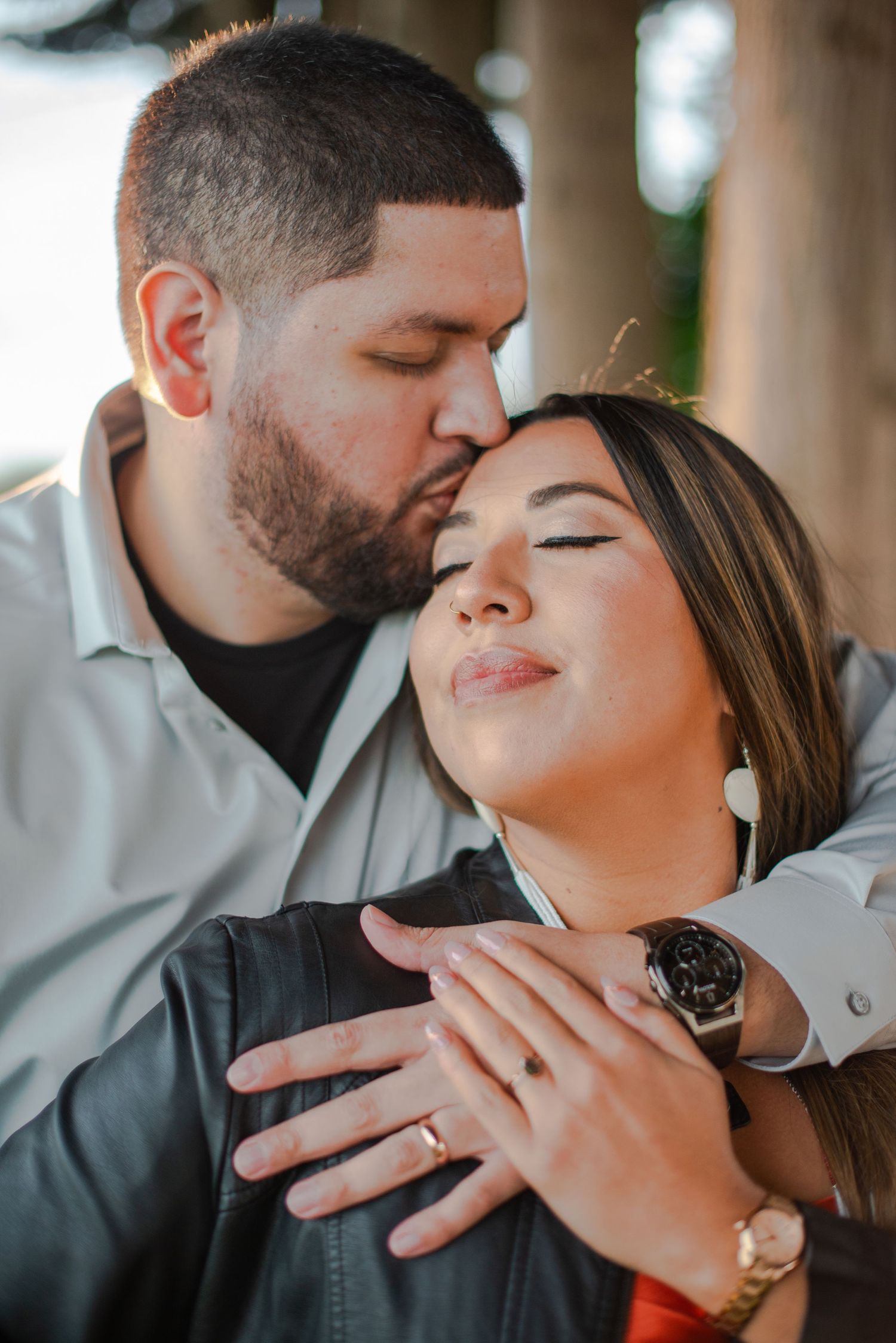 Romantic moment captured in soft lighting with jewelry and intimate gestures. Knoxville Couple Photographer