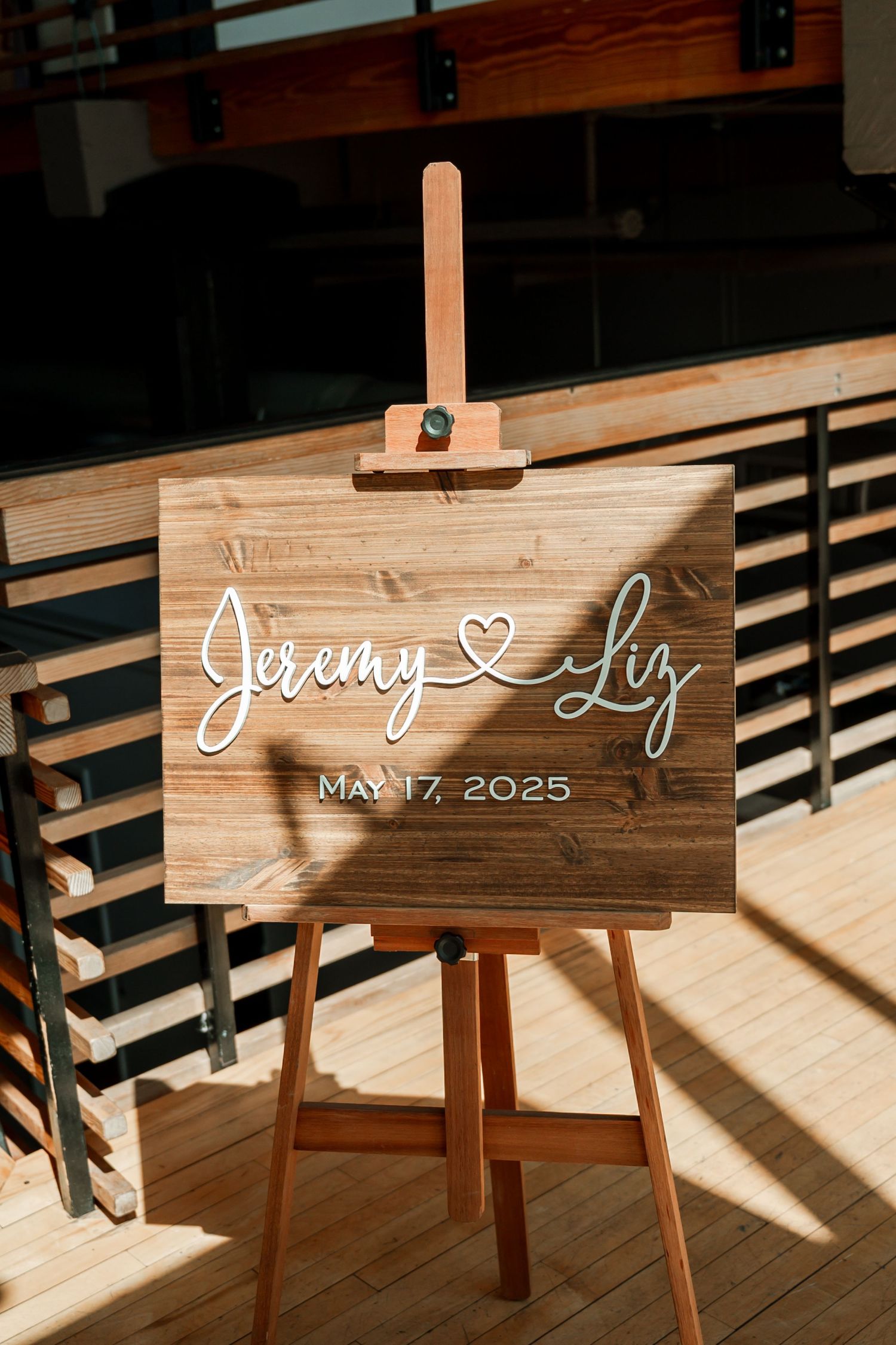 Wooden wedding signs displaying names and date in sunlit venue space. Knoxville Wedding Photographer. Emporium Center