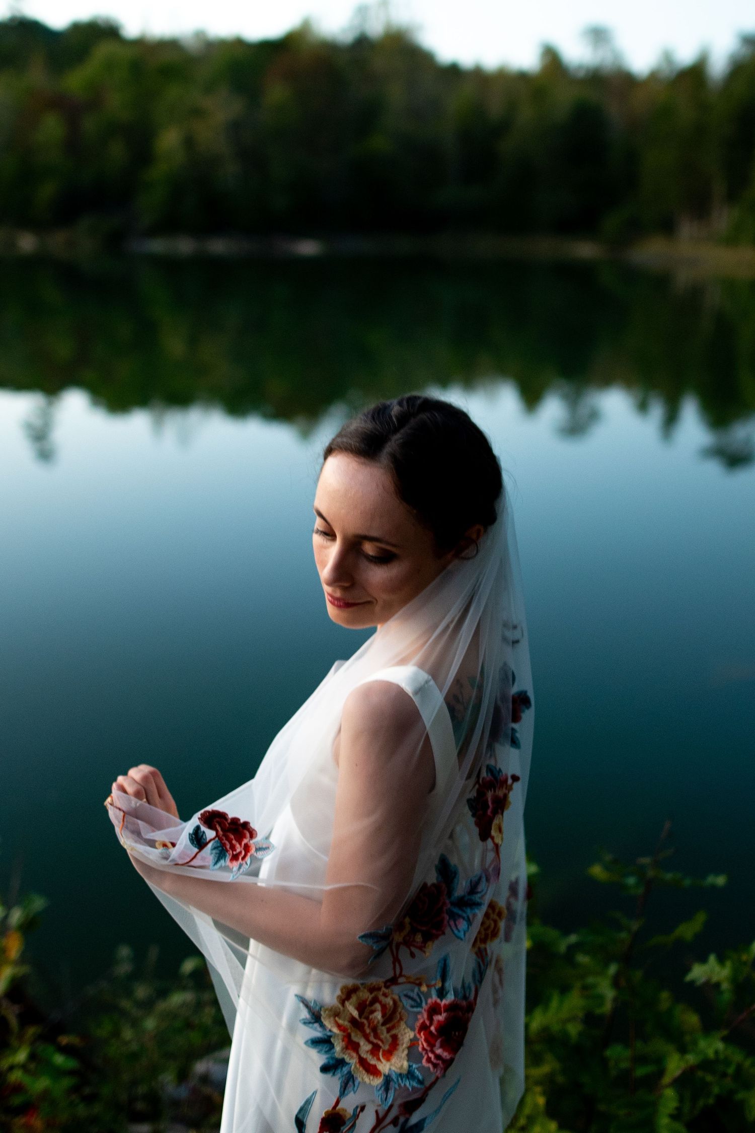 Dreamy bridal portraits by a serene lake with reflections at dusk. Knoxville Wedding Photographer