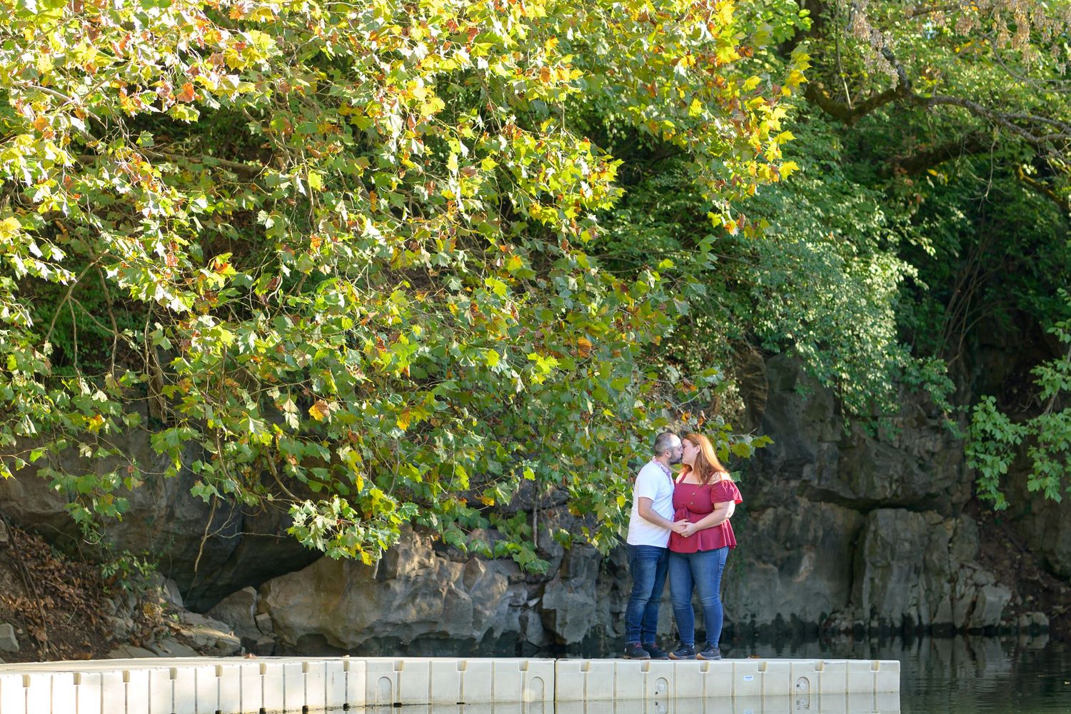 A couple walking together in a scenic park with autumn foliage. Knoxville Couple Photographer