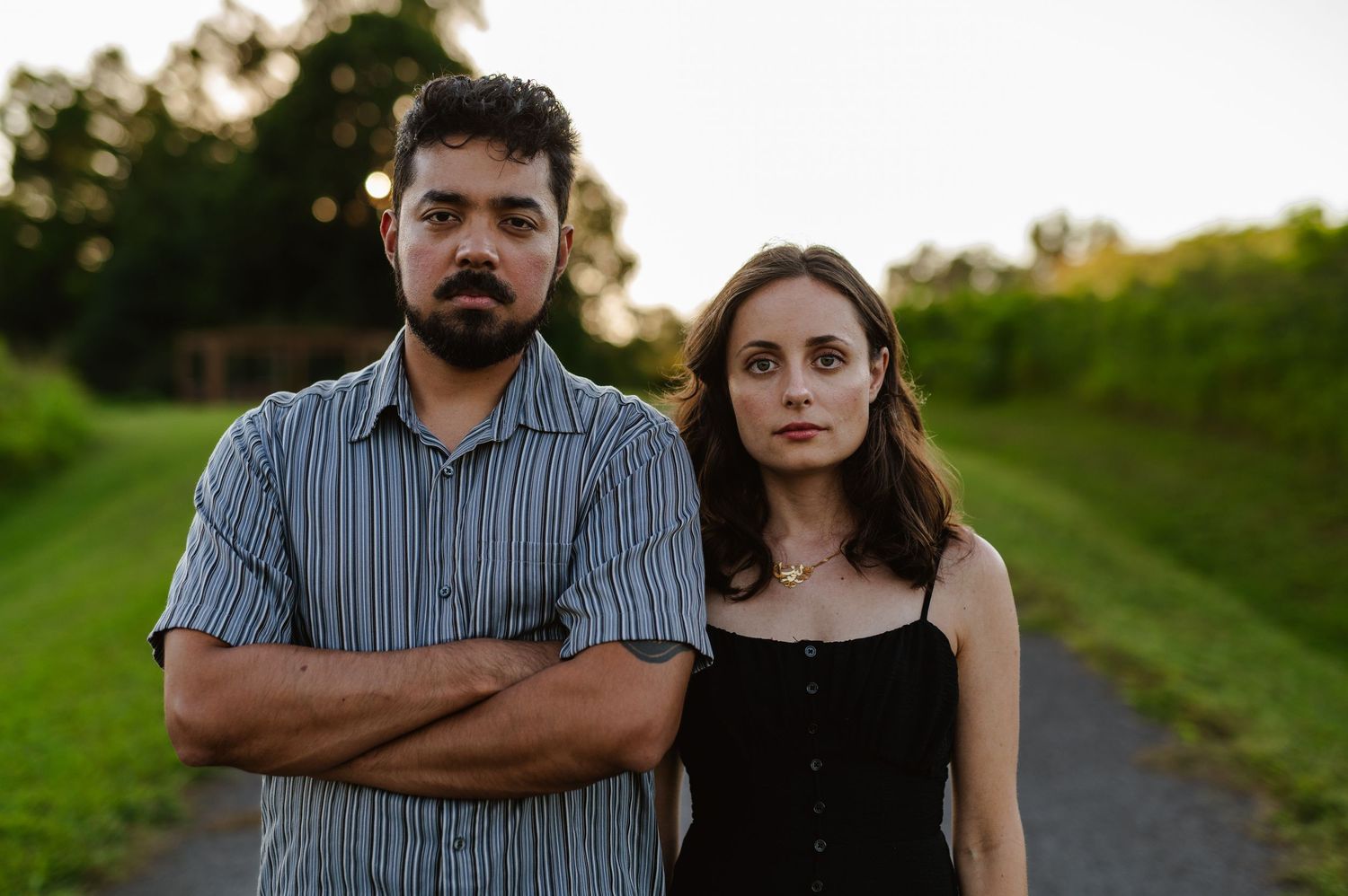 Dramatic outdoor portrait of a couple on a path with evening lighting. Knoxville Couple Photographer