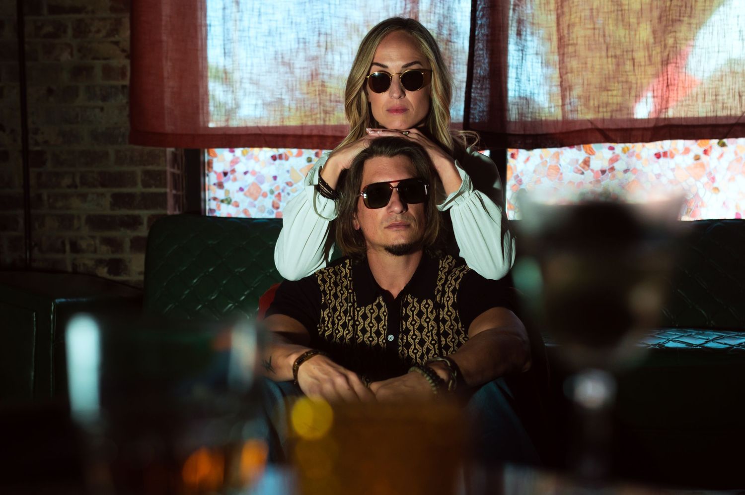 Couple in a dimly lit room wearing sunglasses in an intimate moment. Knoxville Couple Photographer