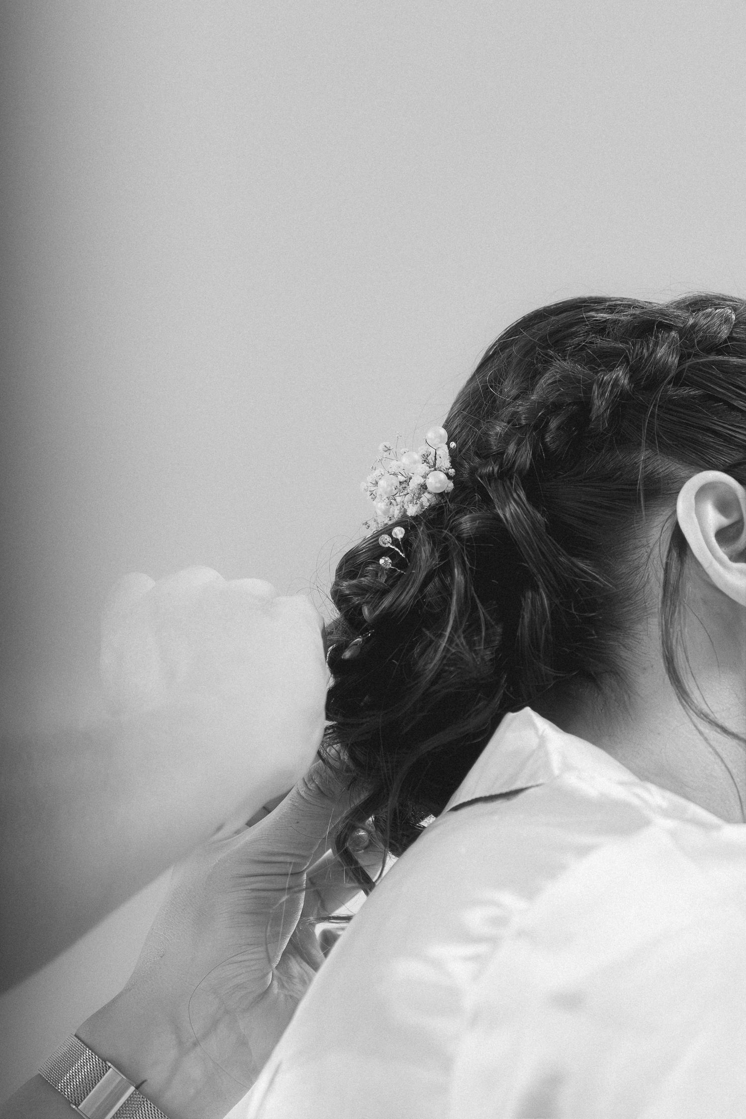Elegant bridal hairstyle progression showing intricate updo styling from multiple angles in black and white photography.