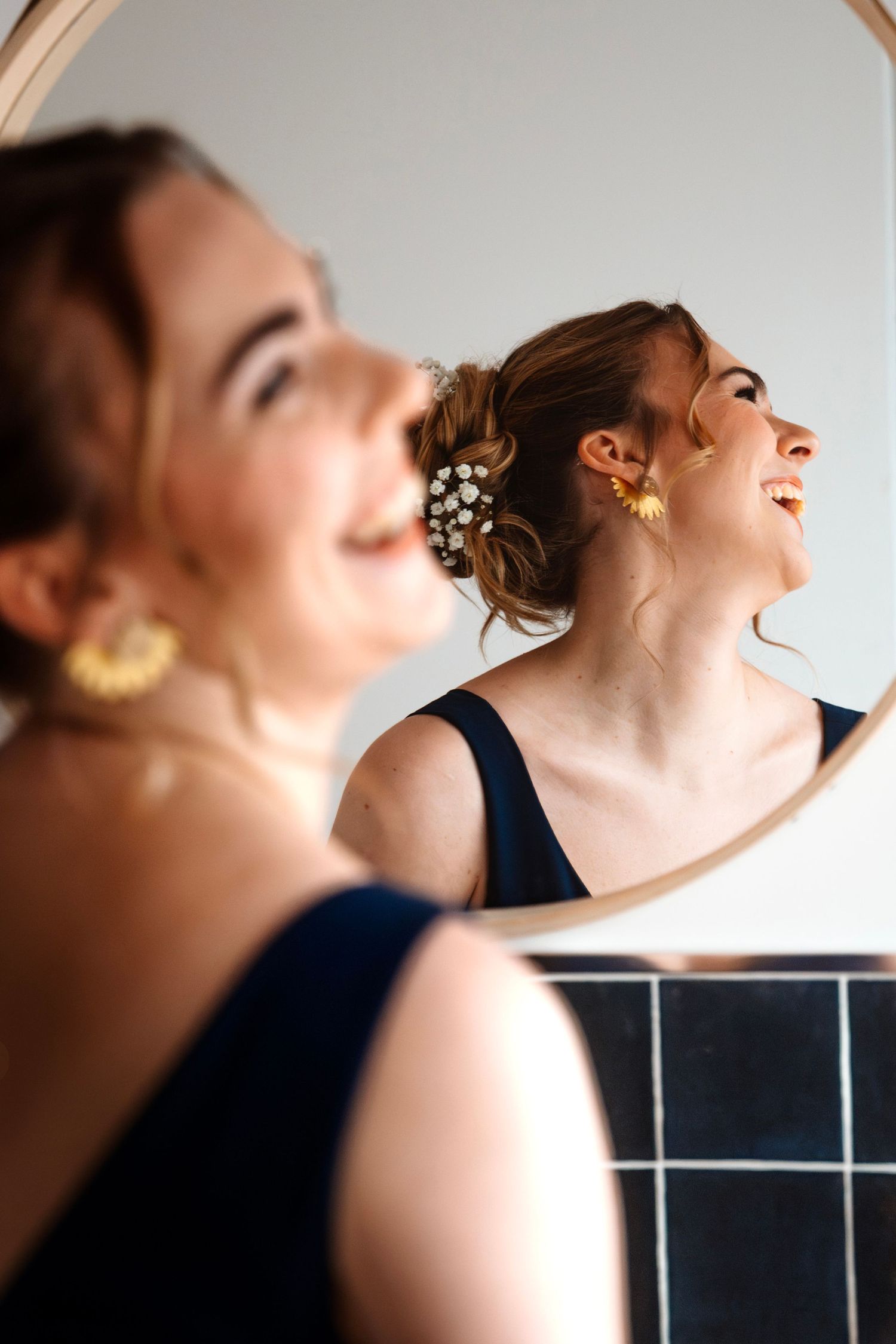 A woman wearing a dark top tilts her head back in a series of artistic profile portraits.