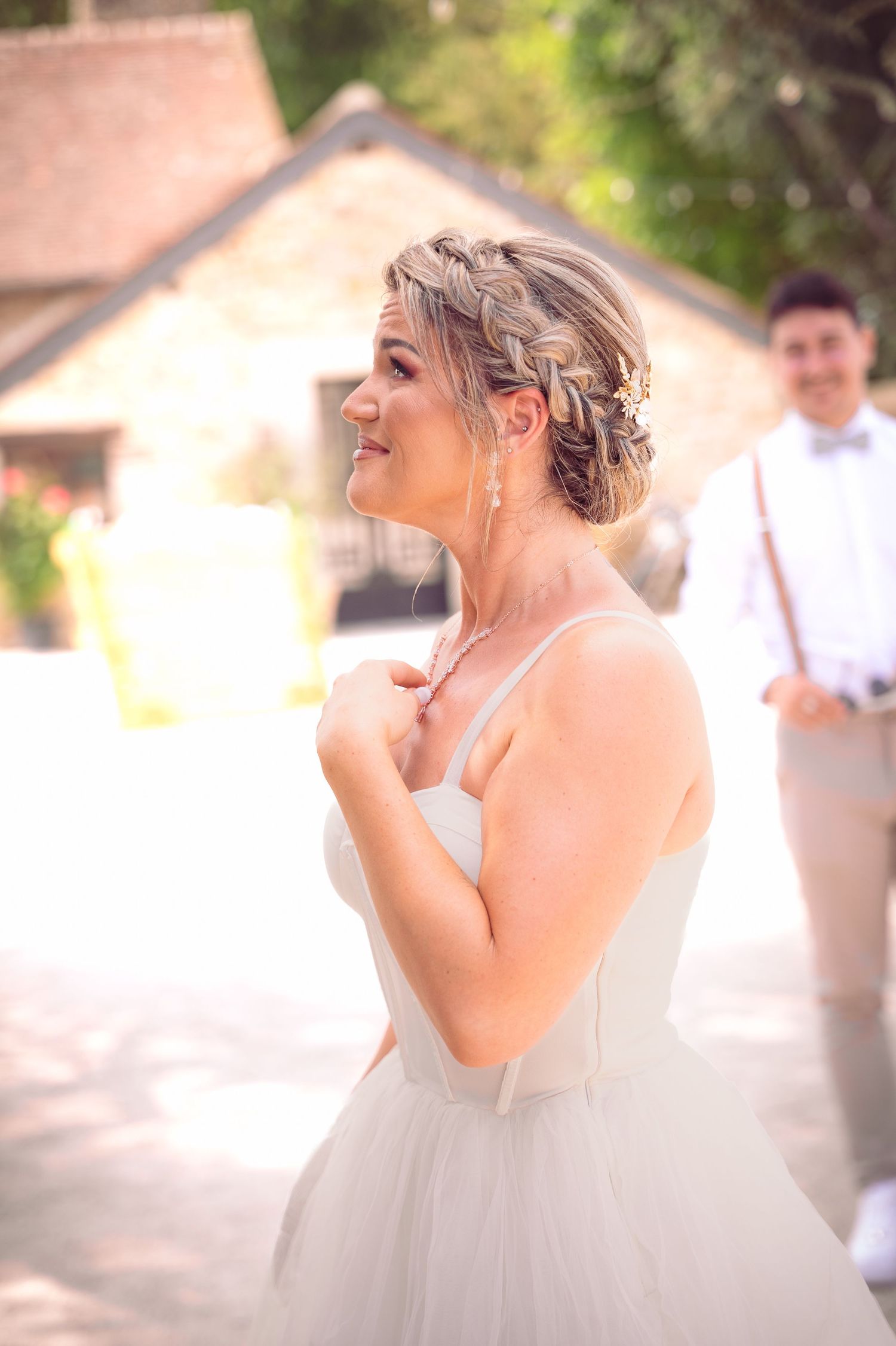 Une mariée en robe de mariée blanche rit joyeusement lors d'une fête de mariage en plein air.