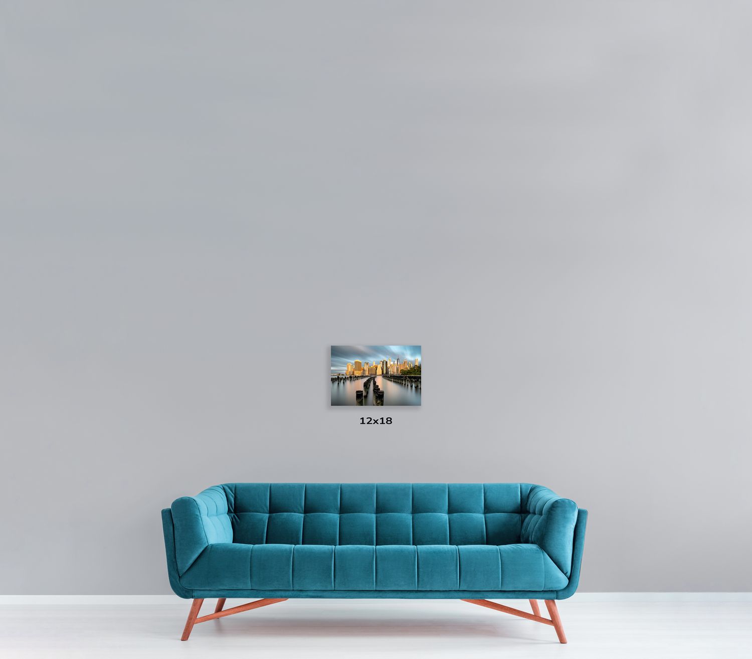 Designer blue couch with channel-tufted backrest displayed with urban photography wall art.