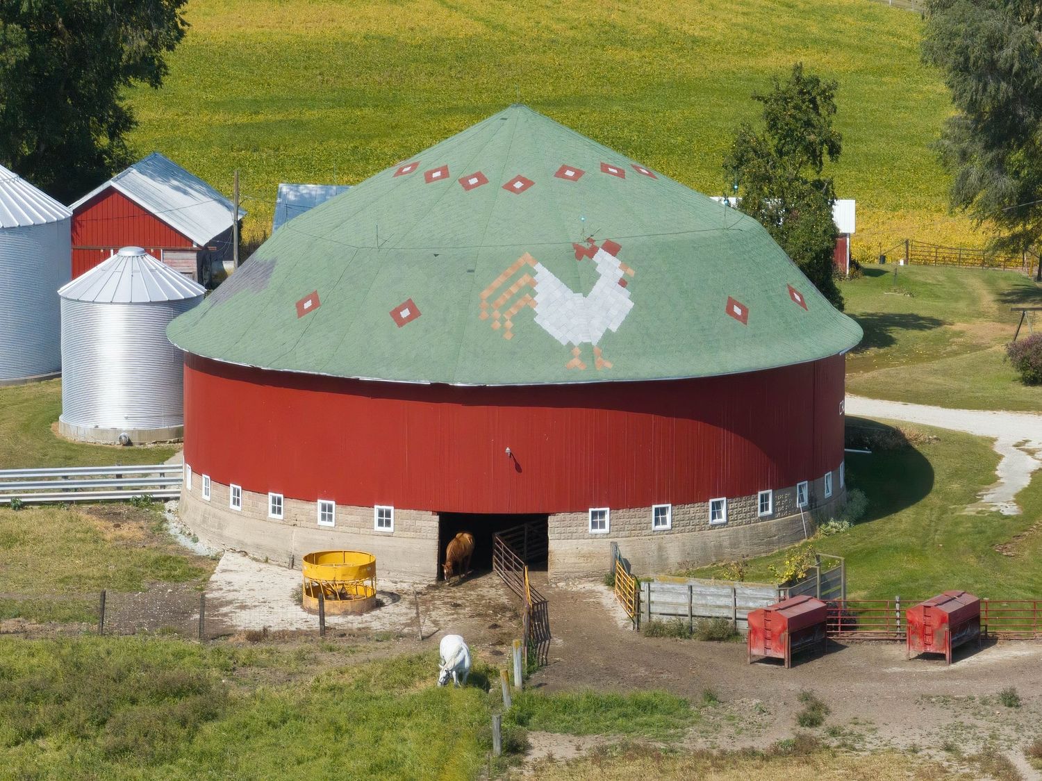 Aerial view of the John Weller Calloway barn and farm in Indiana's rural countryside with two horses and a chicken motif on the roof.