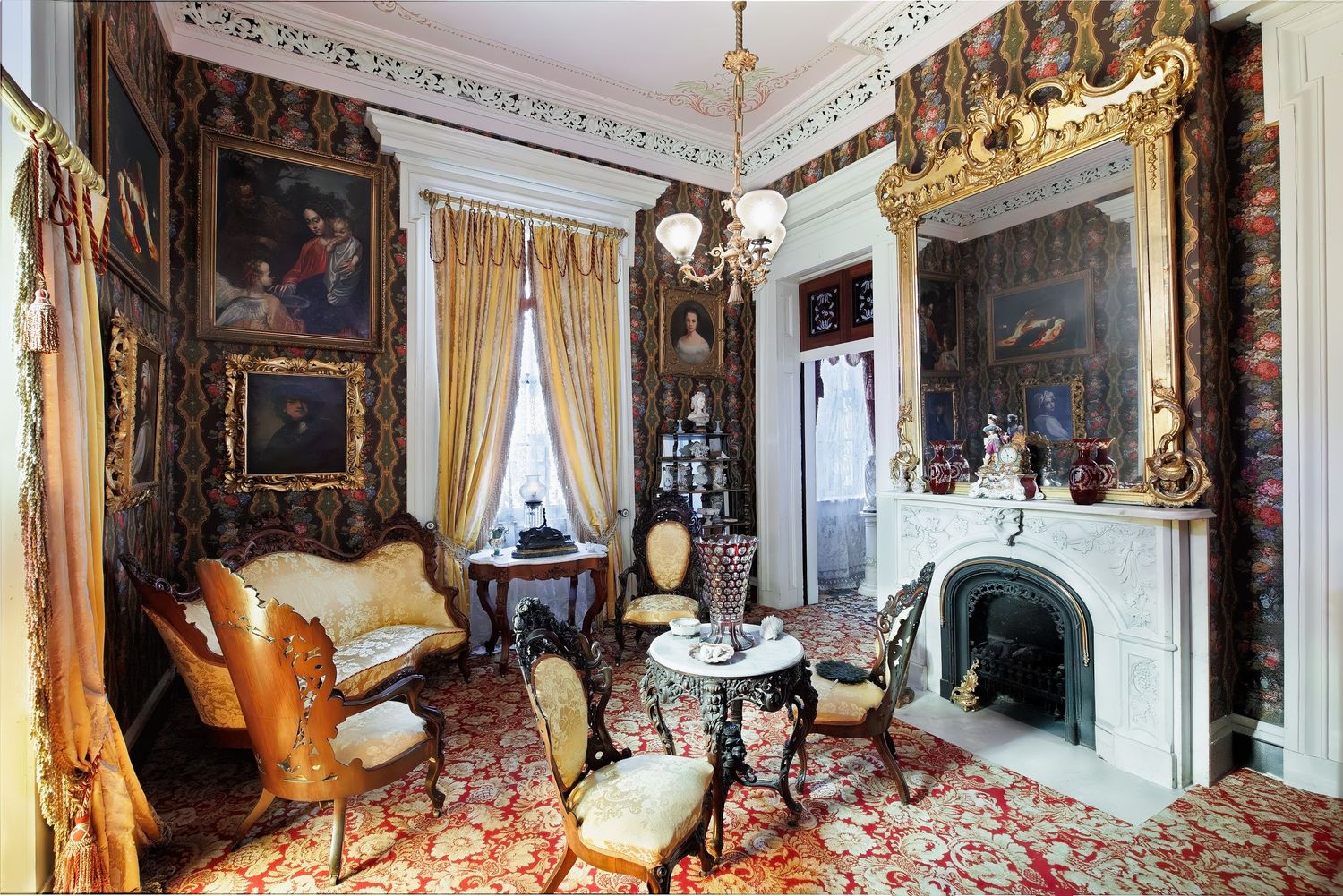 Historic Belmont mansion interior featuring antique furniture, artwork, fireplace and architectural details in Nashville, Tennessee.