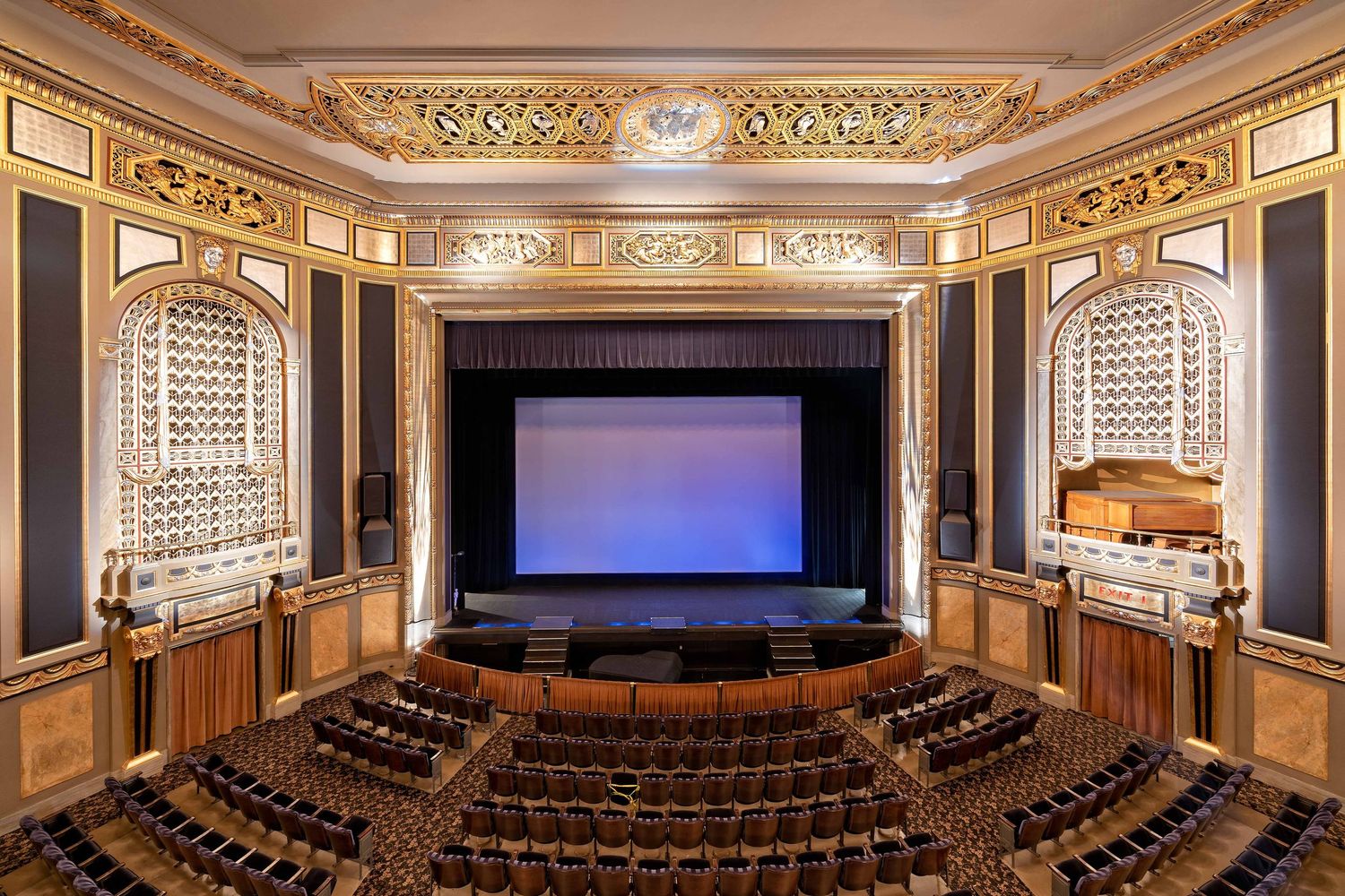 Detroit Film Theatre panoramic image from the balcony showing ornate gold trim, tiered seating, and the stage with a screen.