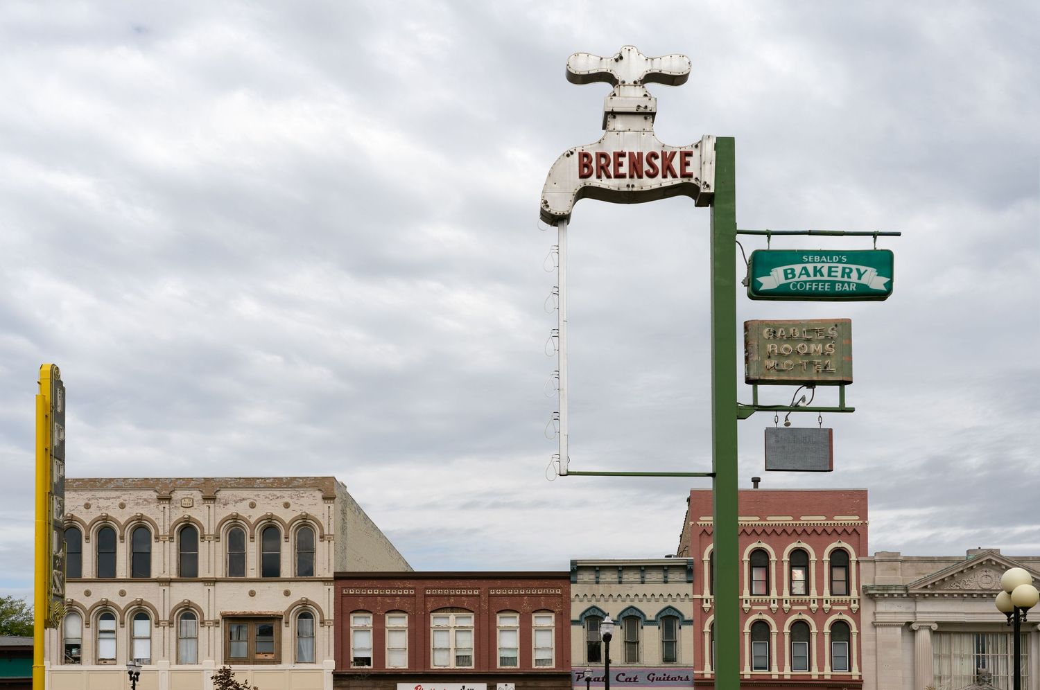 Collection of vntage business signs including cleaners and retail stores in Saginaw, Michigan.