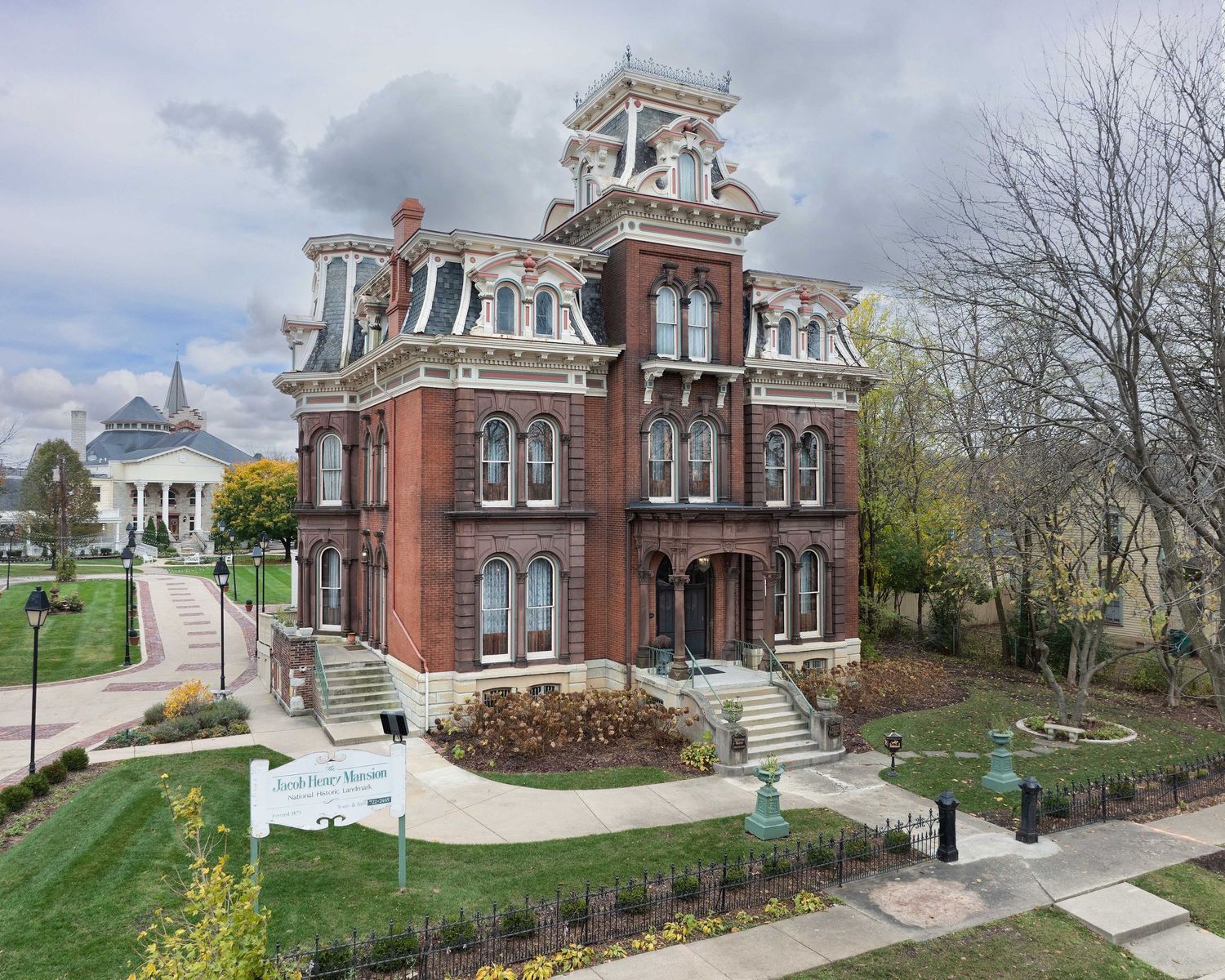 Ornate Jacob Henry victorian mansion with decorative architectural details and manicured lawns in Joliet, Illinois.
