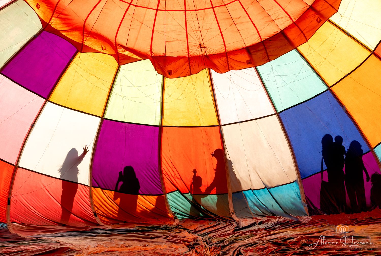 Silhouettes of people visible through illuminated hot air balloon fabric during the Metamora Hot Air Balloon festival in Metamora, Michigan.