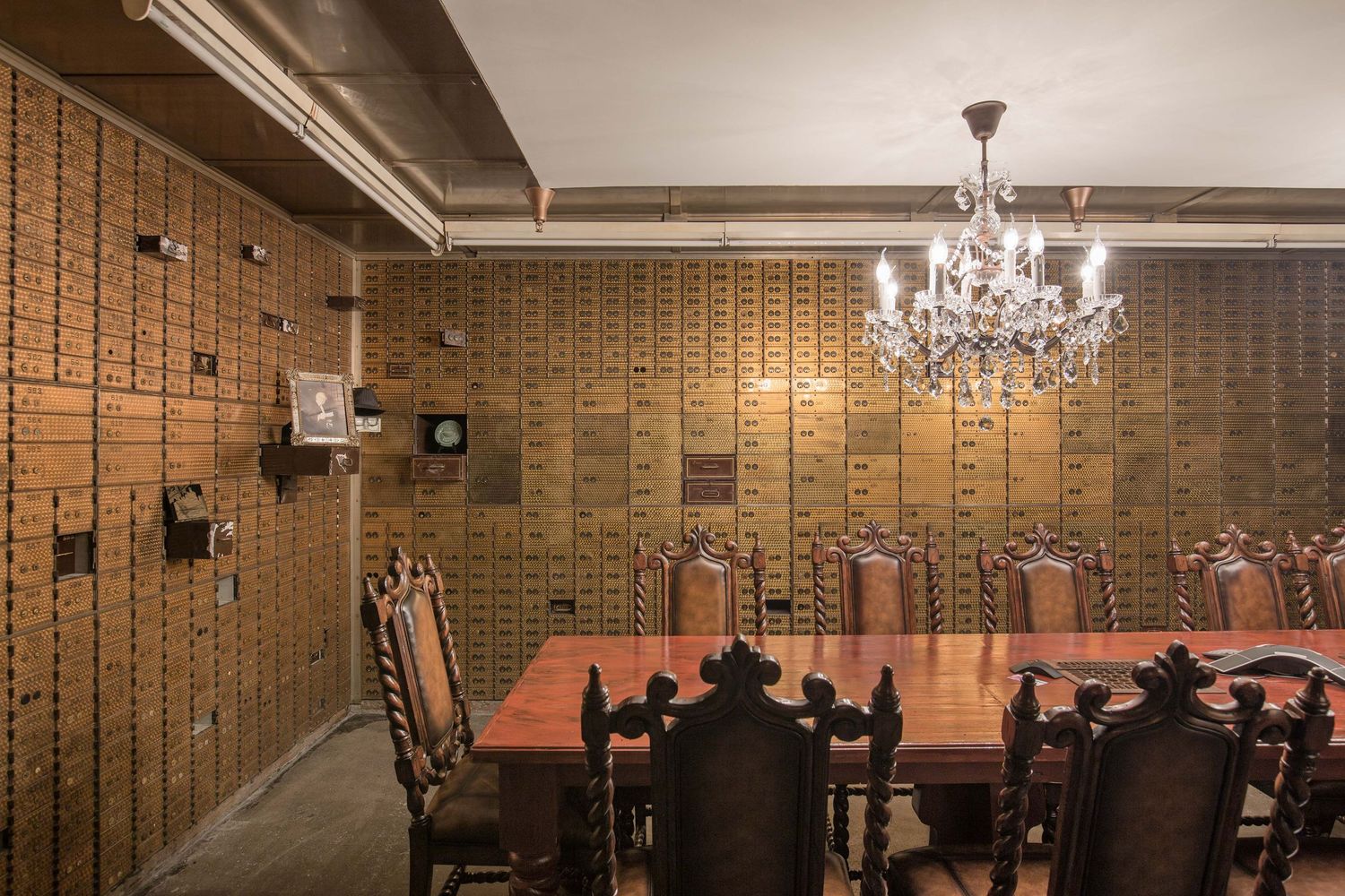 Interior of the old bank vault with conference room table and chairs and a crystal chandelier at the Chrysler House in Detroit, Michigan.