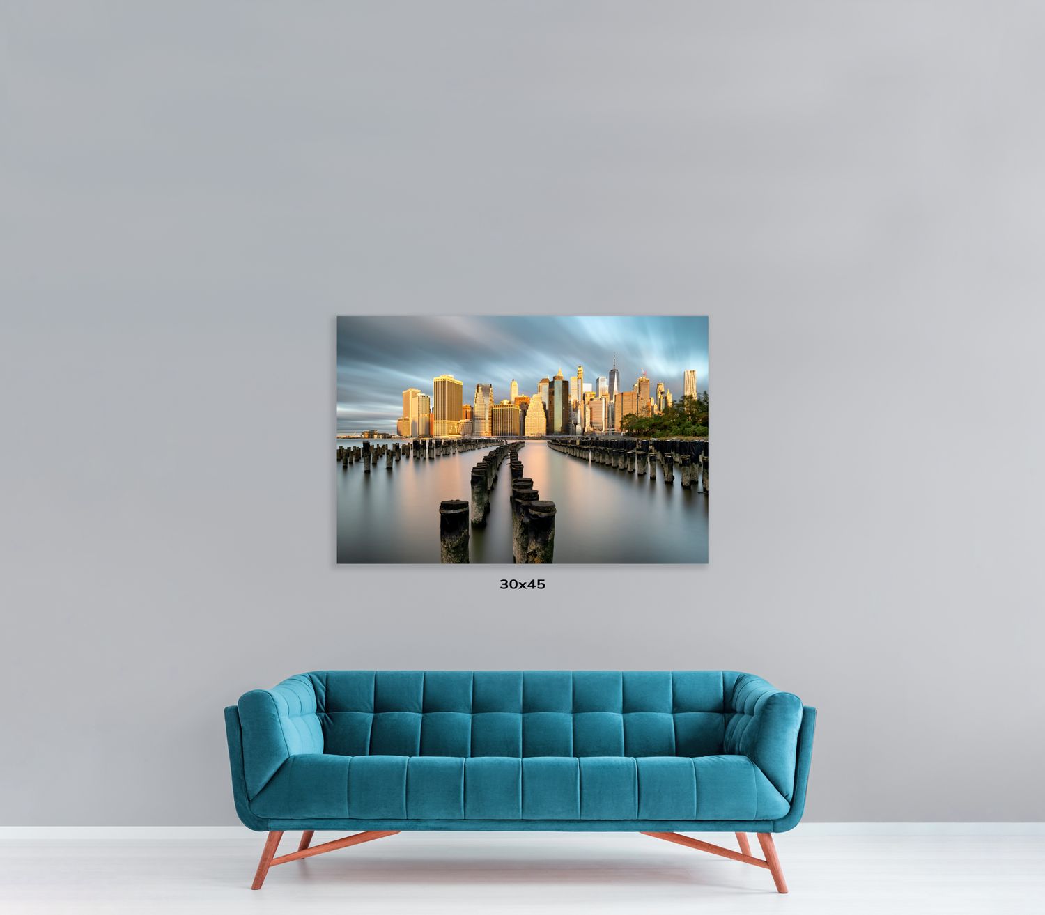 Designer blue couch with channel-tufted backrest displayed with urban photography wall art.