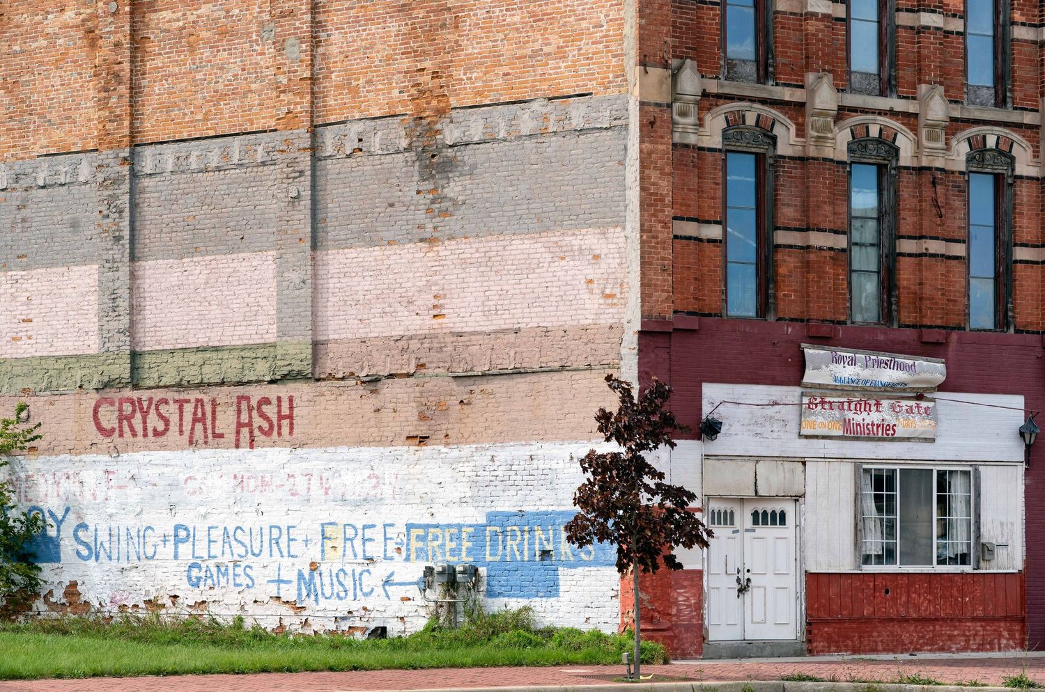 Run down church and painted sign for drinks and party in Saginaw, Michigan.