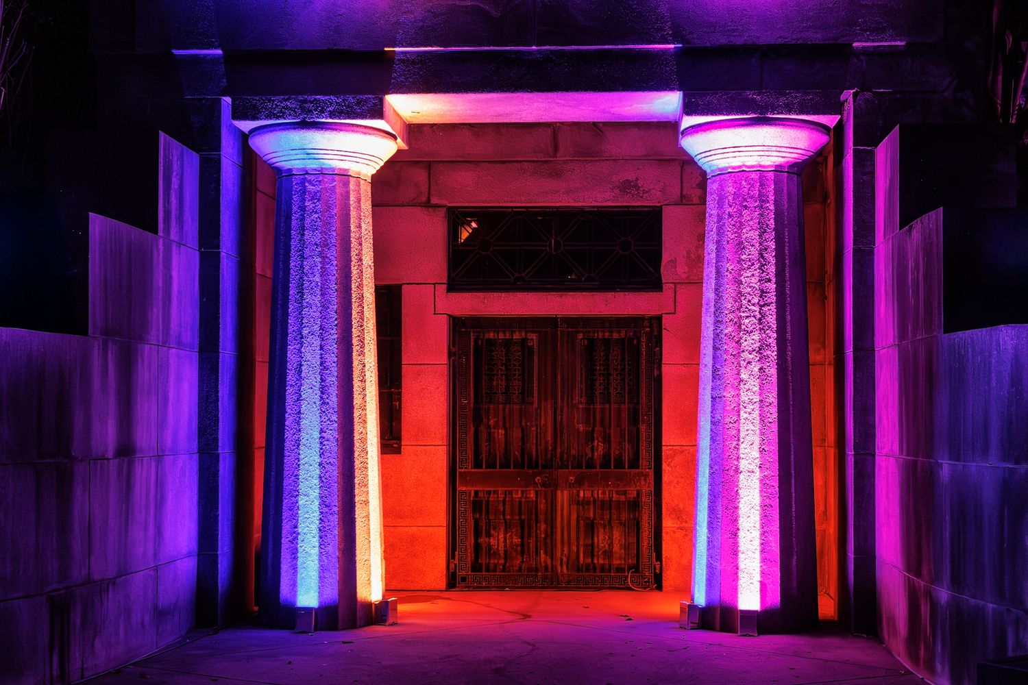 Mausoleum at the Elmwood cemetery in Detroit Michigan with vibrant purple and red LED lights creating a futuristic ambiance.