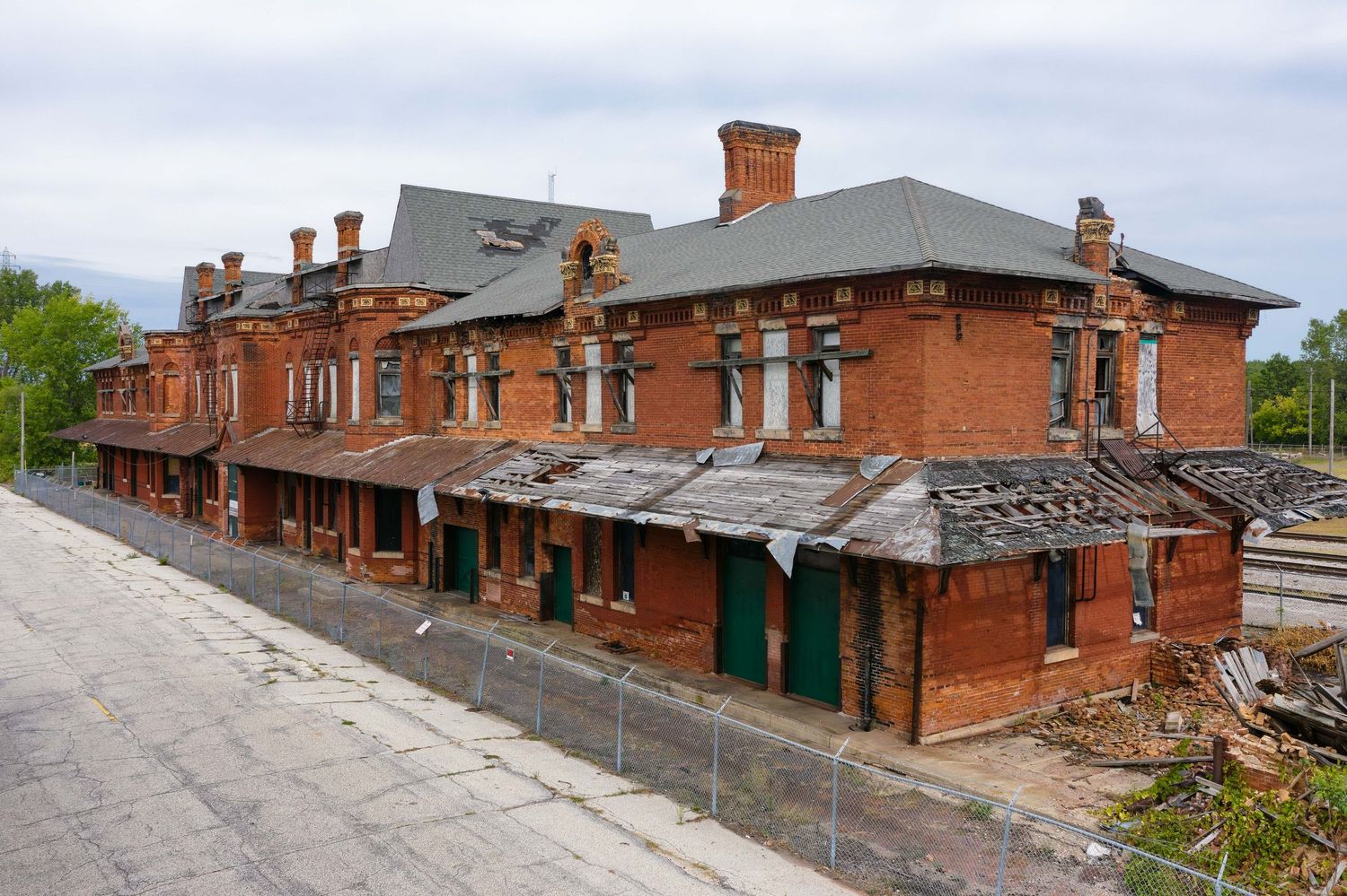 Exterior side view with drone of abandoned Potter Street train station in Saginaw, Michigan with architectural details.