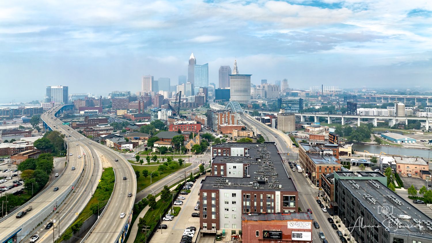 Panoramic aerial view of the downtown Cleveland Ohio skyline and highways during an overcast day with haze from wildfires.