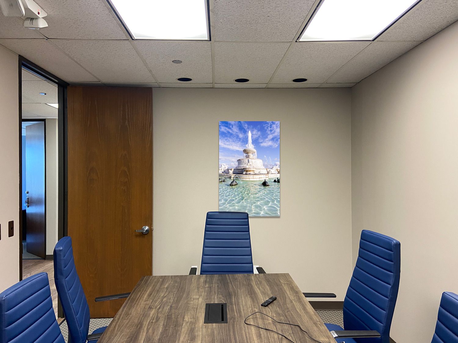 Office conference room with blue chairs and decorative wall art featuring the Scott fountain on Belle Isle in Detroit, Michigan.