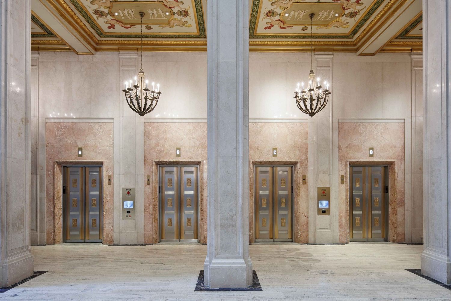 Book Tower lobby elevators in downtown Detroit, Michigan with ornate ceiling, marble columns and classic chandeliers.