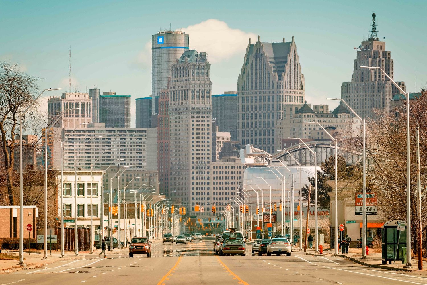 Detroit city skyline view from street level showing historic buildings looking down Grand River Avenue.