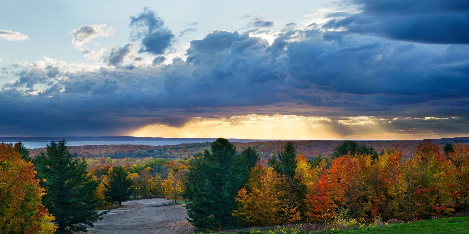 Dramatic panoramic light rays with dark storm clouds over the Little Traverse Nature Conservancy in Michigan.