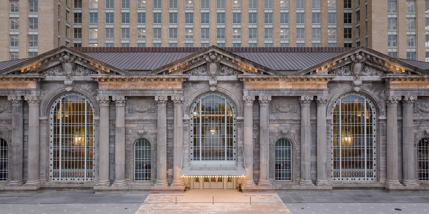 Panoramic view of the Michigan Train Station historic building exterior in Detroit with ornate details and columns after the renovation.