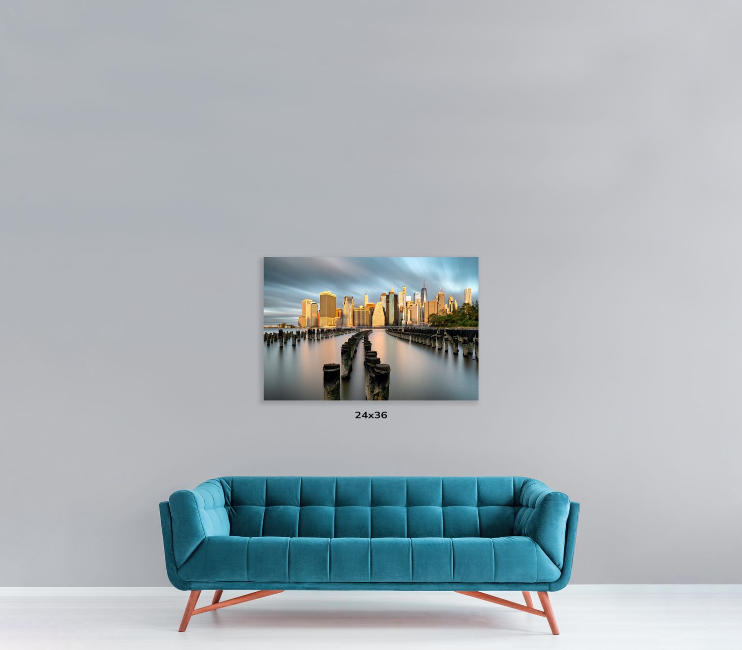 Designer blue couch with channel-tufted backrest displayed with urban photography wall art.