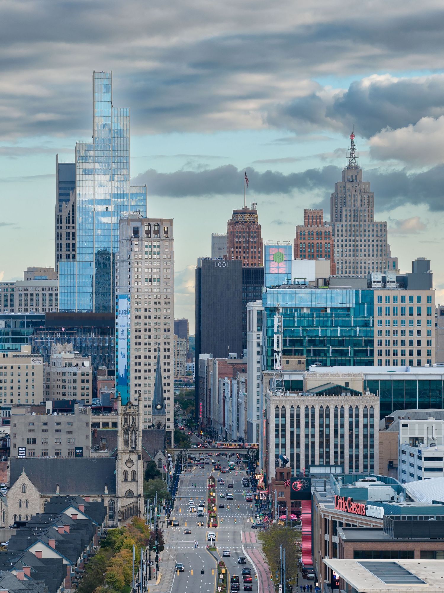 Modern glass buildings and skyscrapers under interesting clouds in downtown Detroit, Michigan captured with drone by Alanna St Laurent.