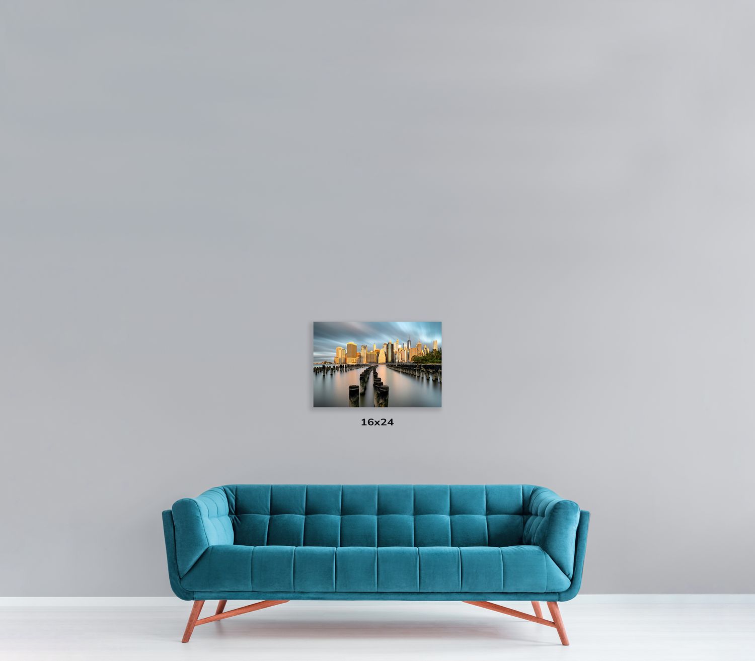 Designer blue couch with channel-tufted backrest displayed with urban photography wall art.