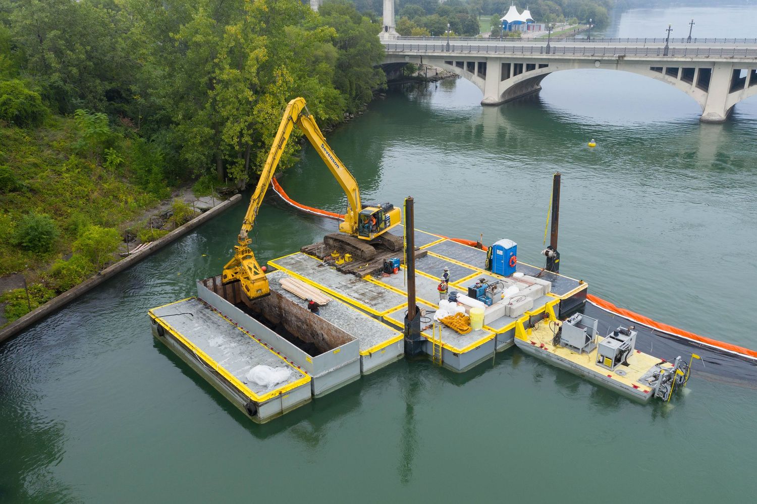 Dredging equipment working on the Uniroyal Detroit river cleanup project with yellow cranes and barges in captured by the Mavic 2 Pro drone.