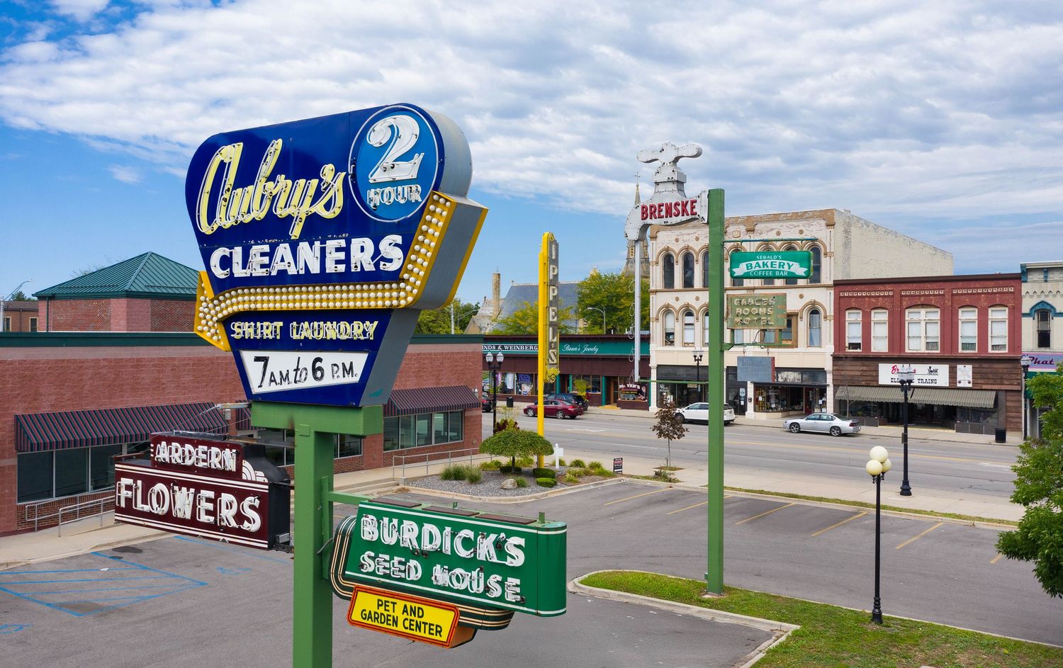 Row of vintage commercial signs and storefronts along Court St in Saginaw, Michigan.