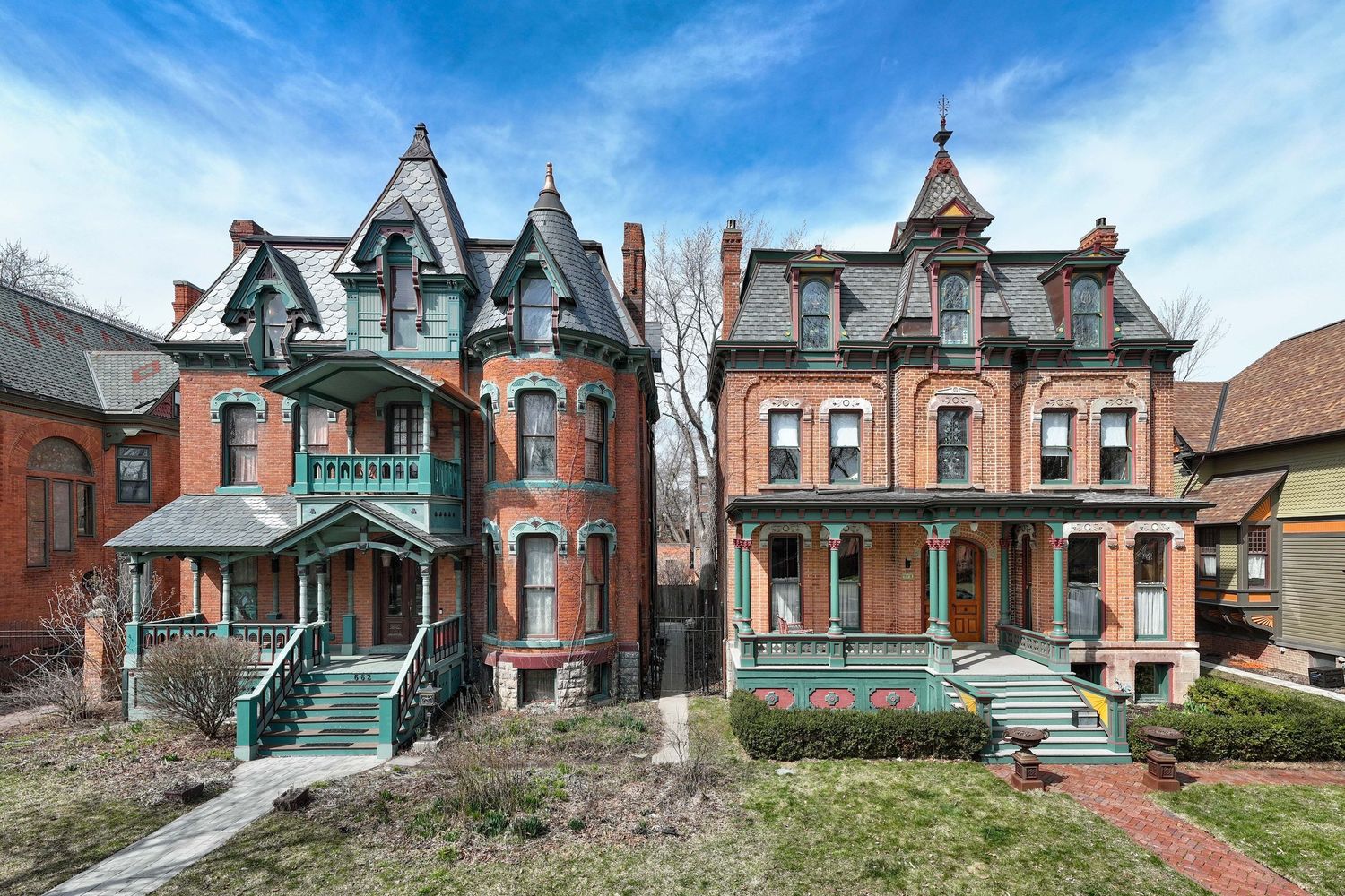Two historic Victorian mansions with ornate architectural details and dormer windows on Canfield Street in Detroit, Michigan.