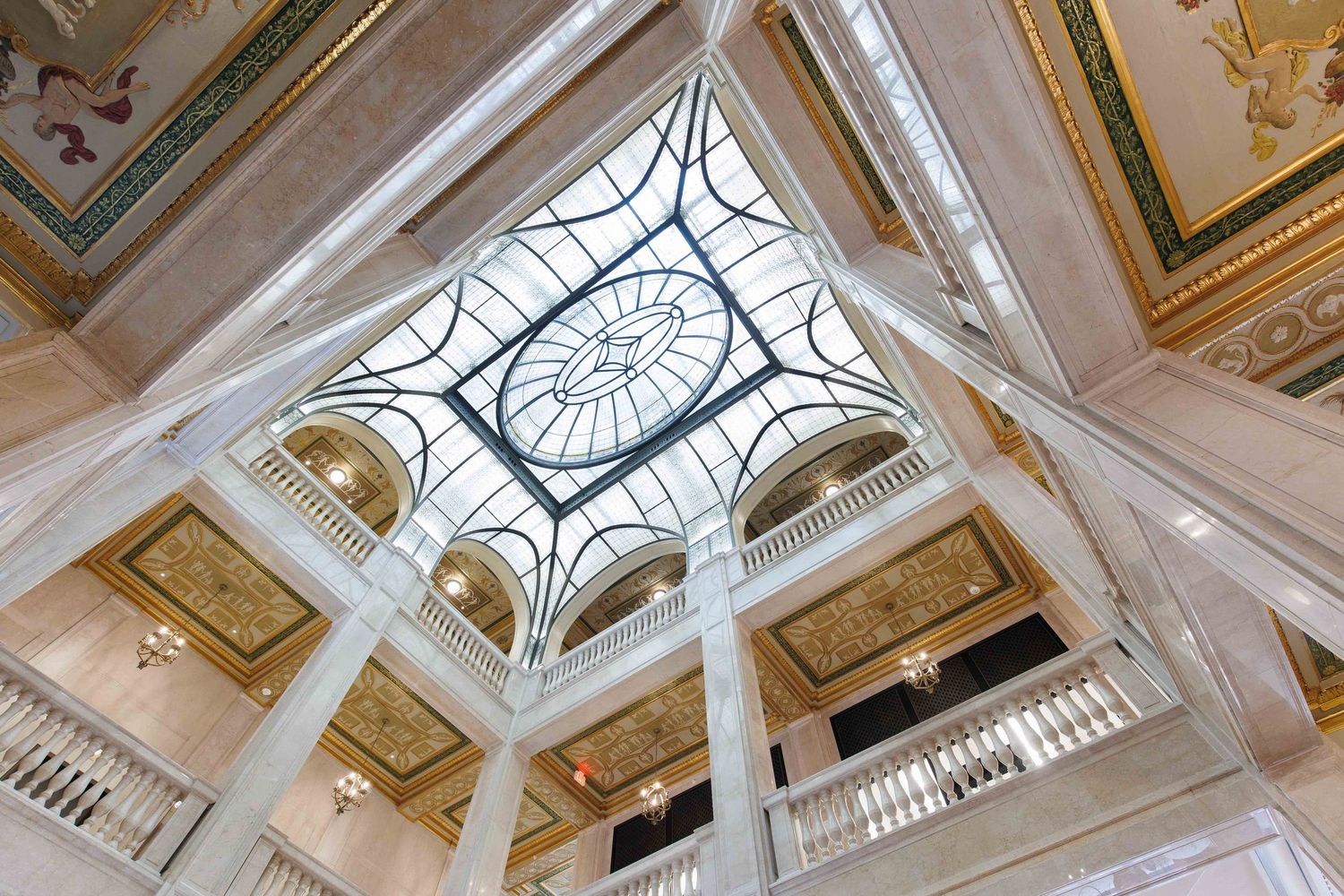 Ornate glass domed ceiling with intricate architectural details and in the historic Book Tower lobby in downtown Detroit, Michigan.