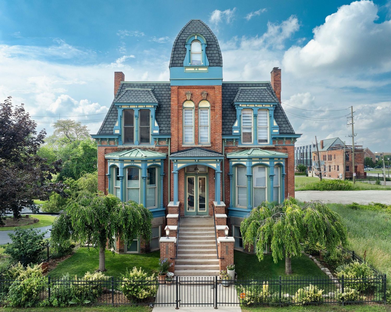 231 Edmund Street mansion with ornate architectural details and landscaped gardens in Brush Park neighborhood of Detroit, Michigan.