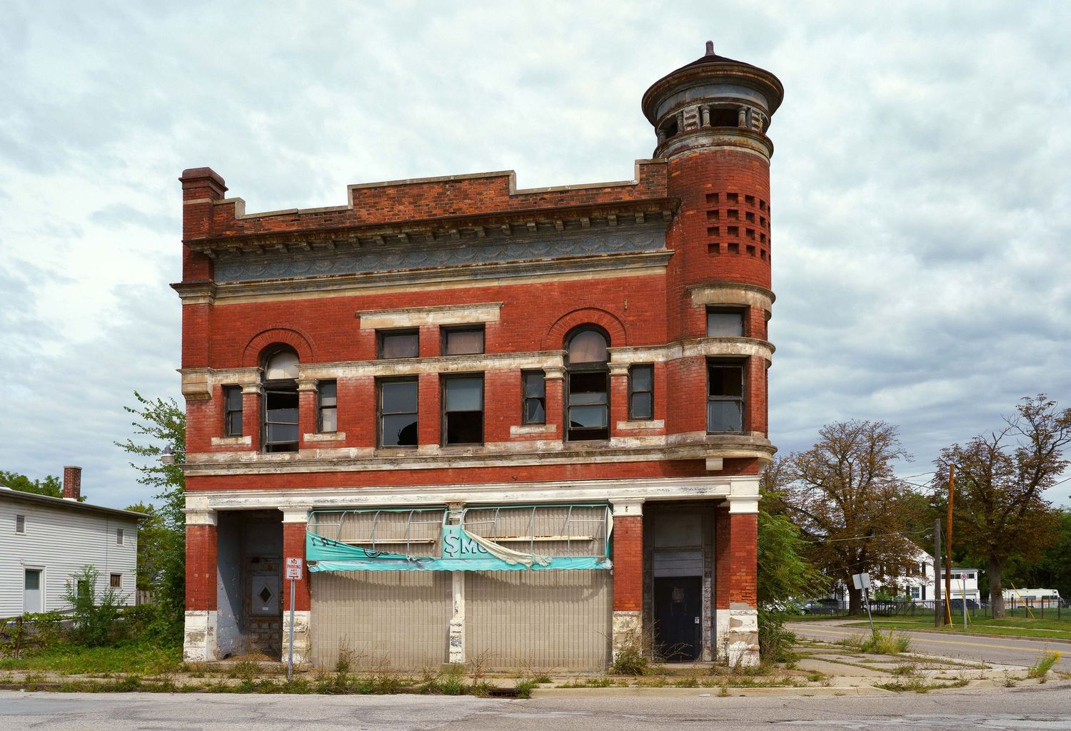 Historic red brick building with tower features and architectural details in Saginaw, Michigan.
