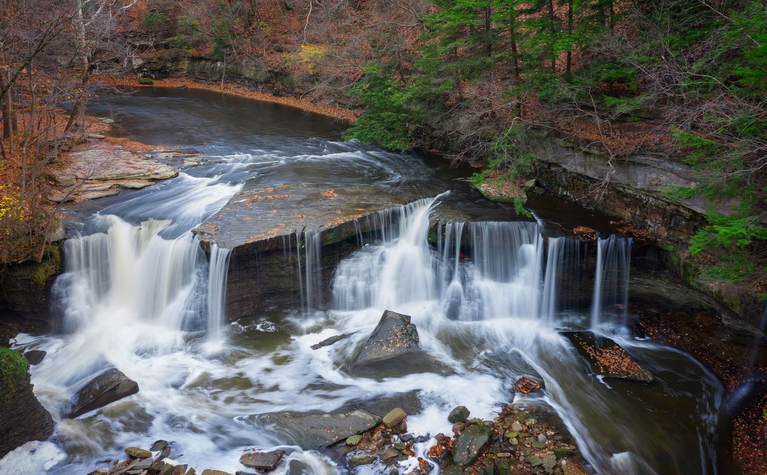 Tinkers Creek waterfalls flowing over rocky terrain captured with a drone in Ohio.