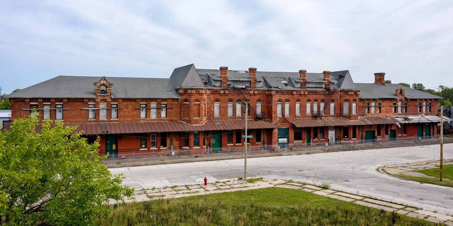 Exterior front view with drone of abandoned Potter Street train station in Saginaw, Michigan with architectural details.
